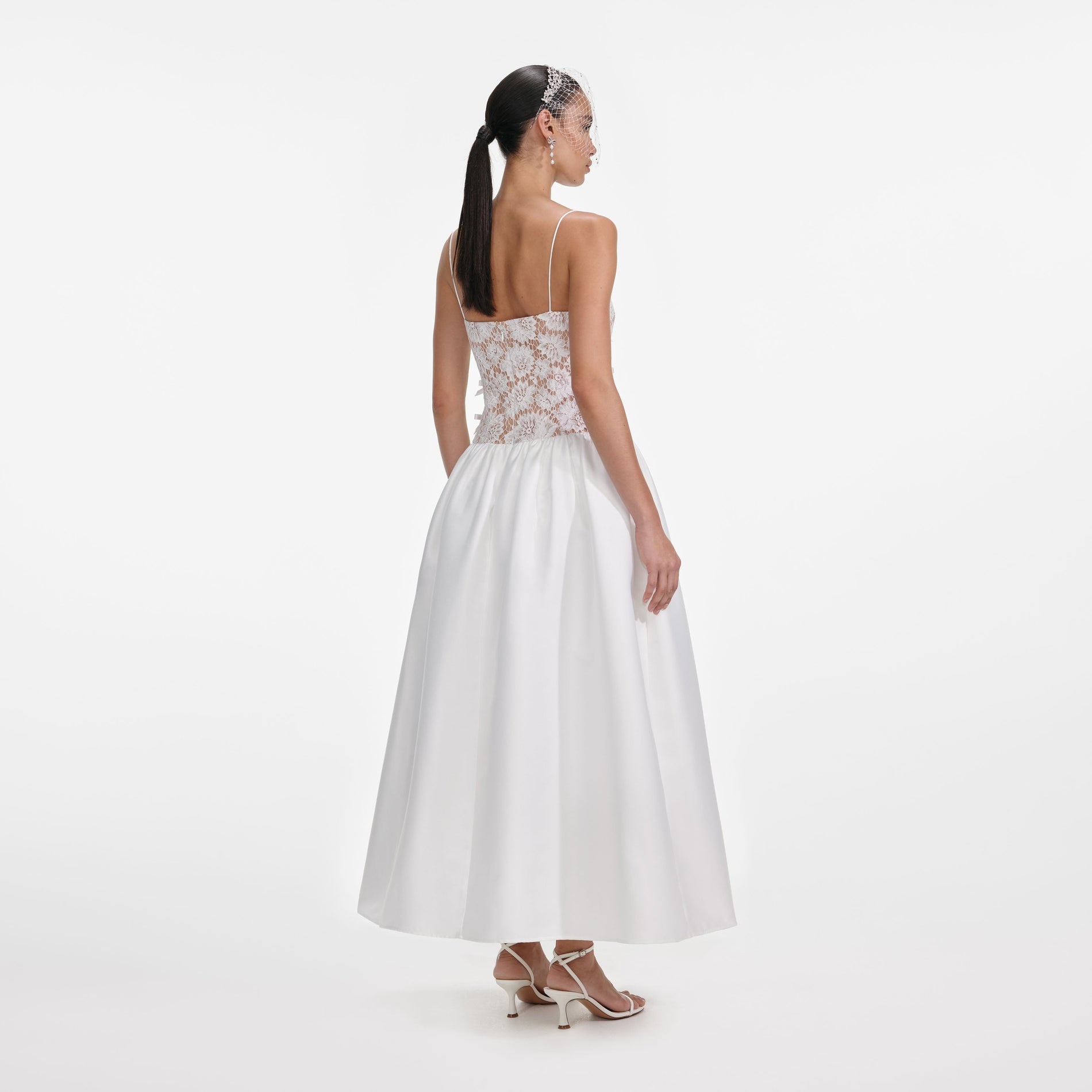 Back view of a woman wearing the White Lace Taffeta Maxi Dress
