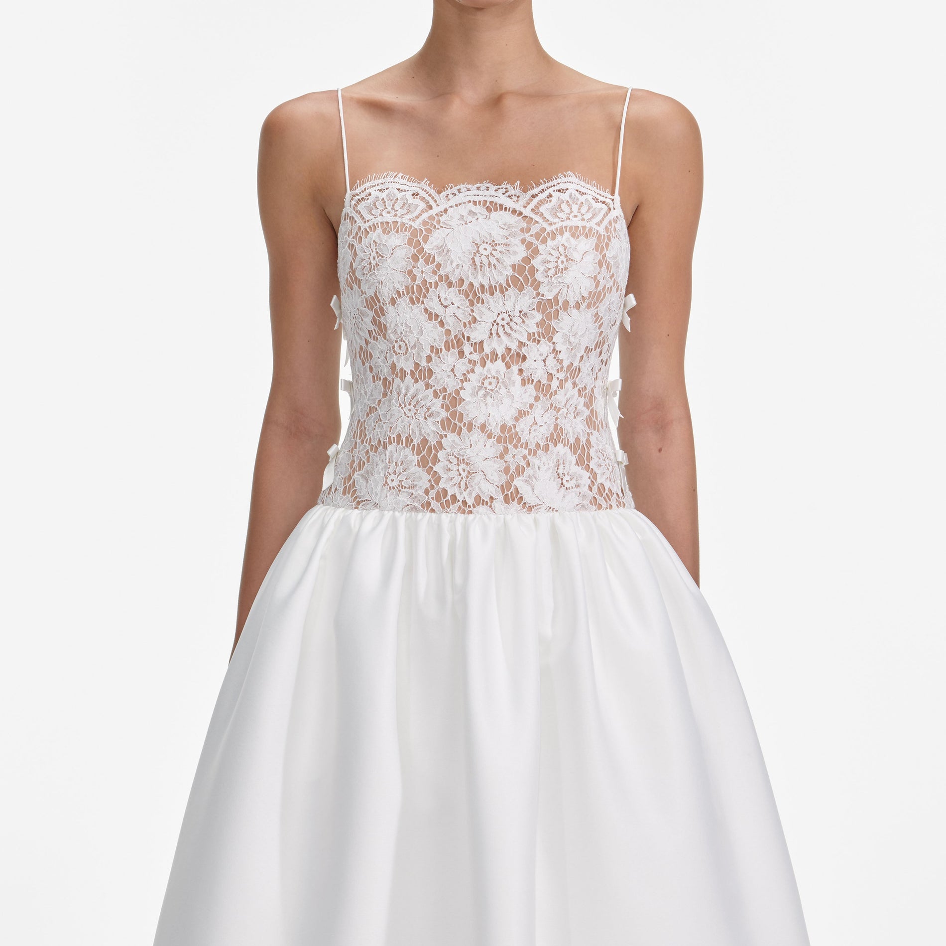 A close up of a woman wearing the White Lace Taffeta Maxi Dress