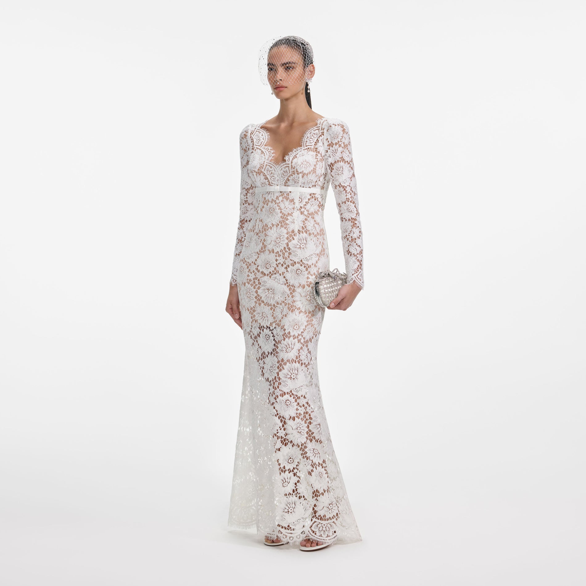 Side view of a woman wearing the White Floral Lace Maxi Dress