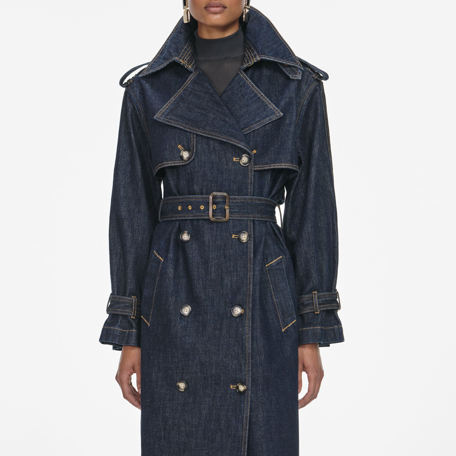 A close up of a woman wearing the Indigo Denim Trench Coat