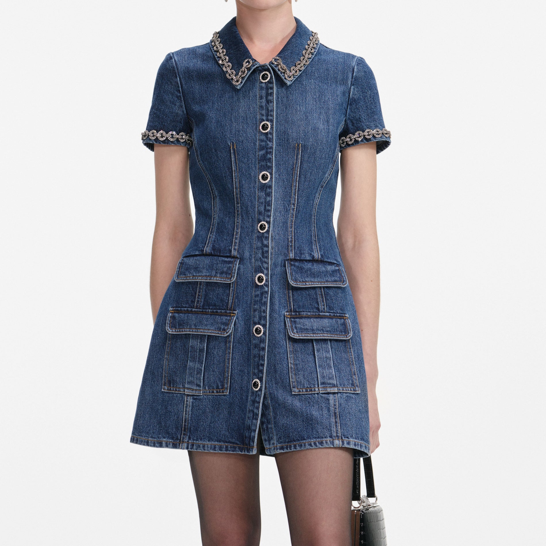 A close up of a woman wearing the Denim Crystal Trim Collared Mini Dress