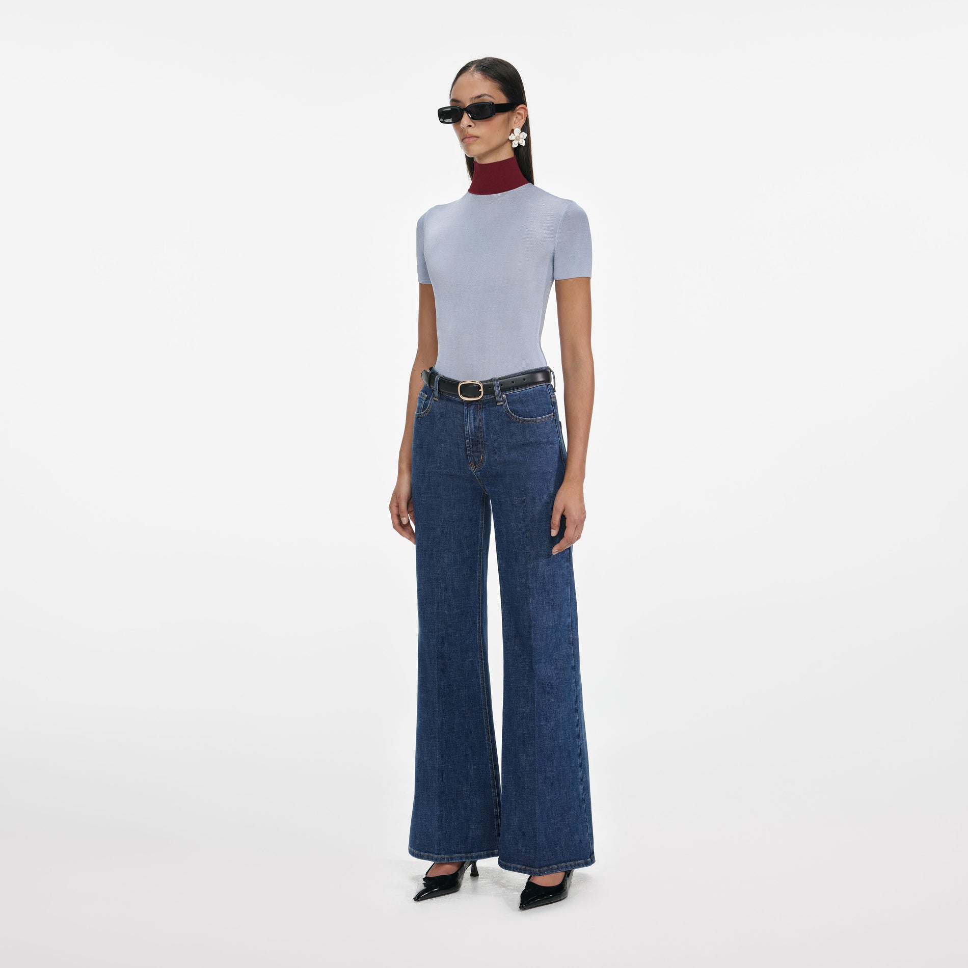 Side view of a woman wearing the Blue Flared Jeans