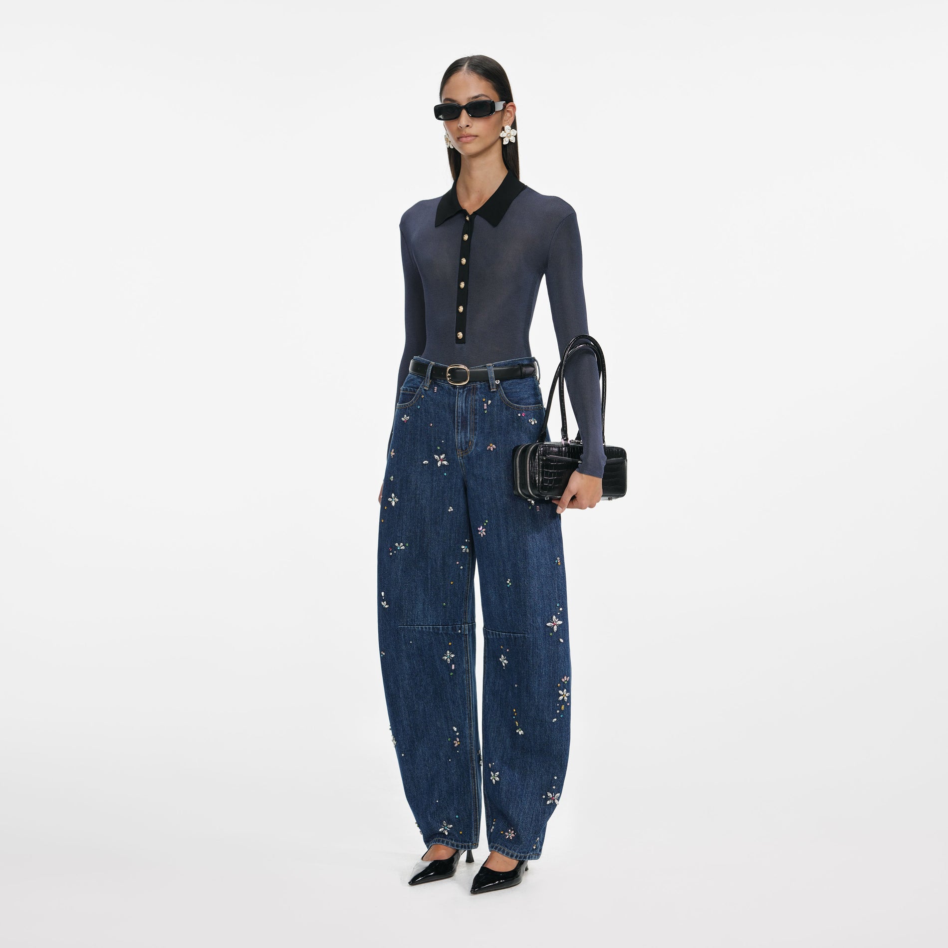 Side view of a woman wearing the Blue Embellished Barrel Leg Jeans