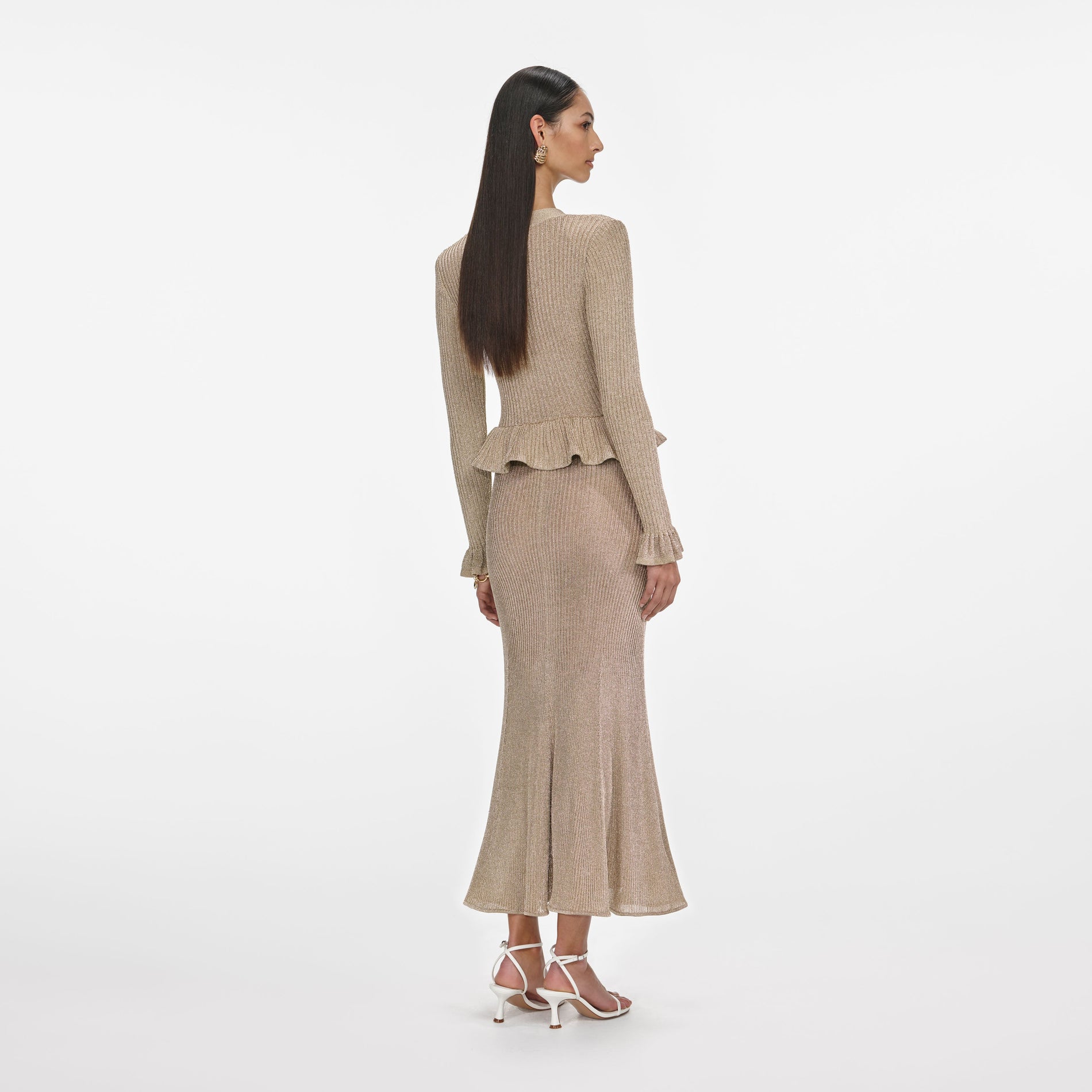 Back view of a woman wearing the Gold Lurex Peplum Knit Midi Dress