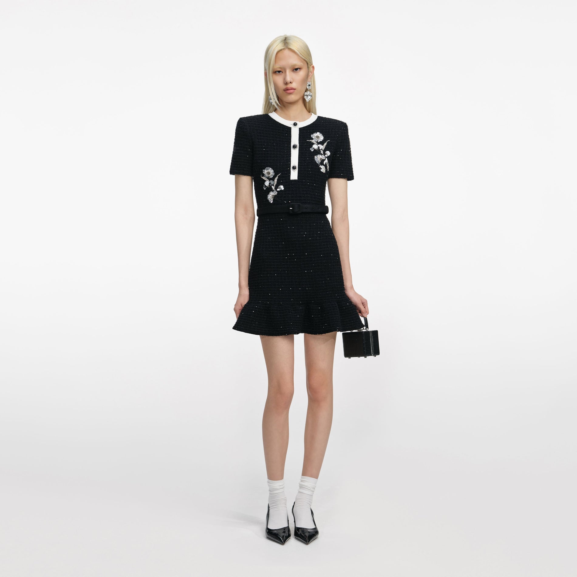 Front view of a woman wearing the Black Floral Textured Knit Mini Dress