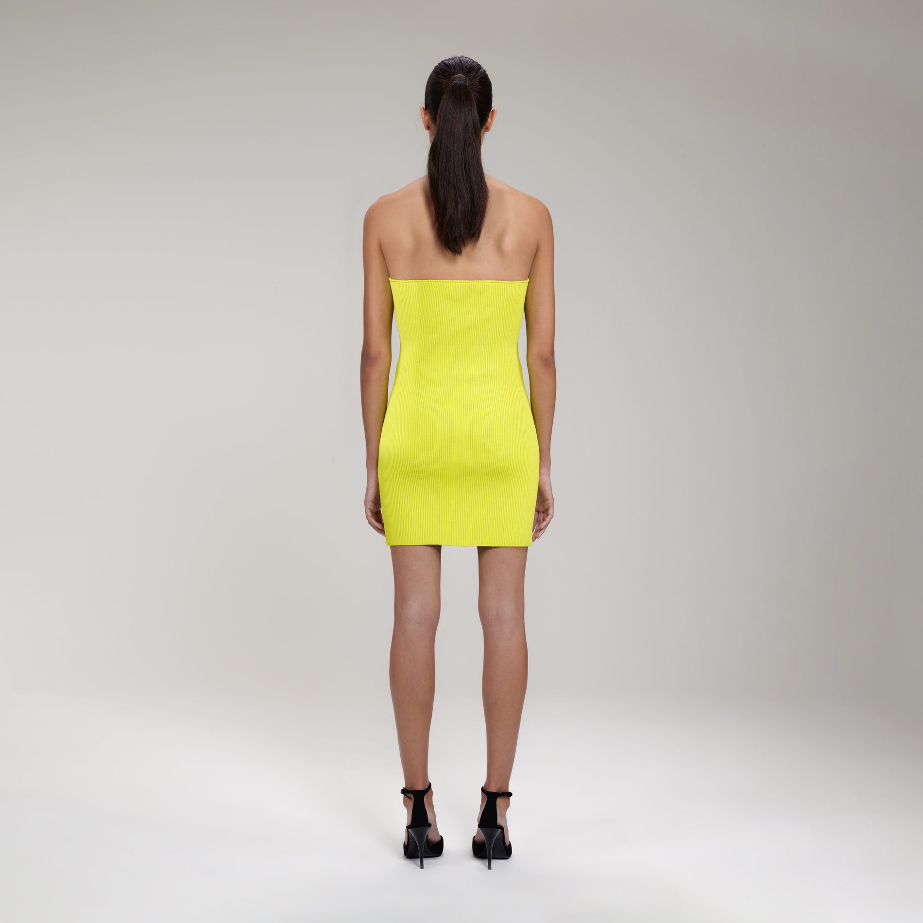 A woman wearing the Lime Inserted Lace Ribbed Knit Mini Dress