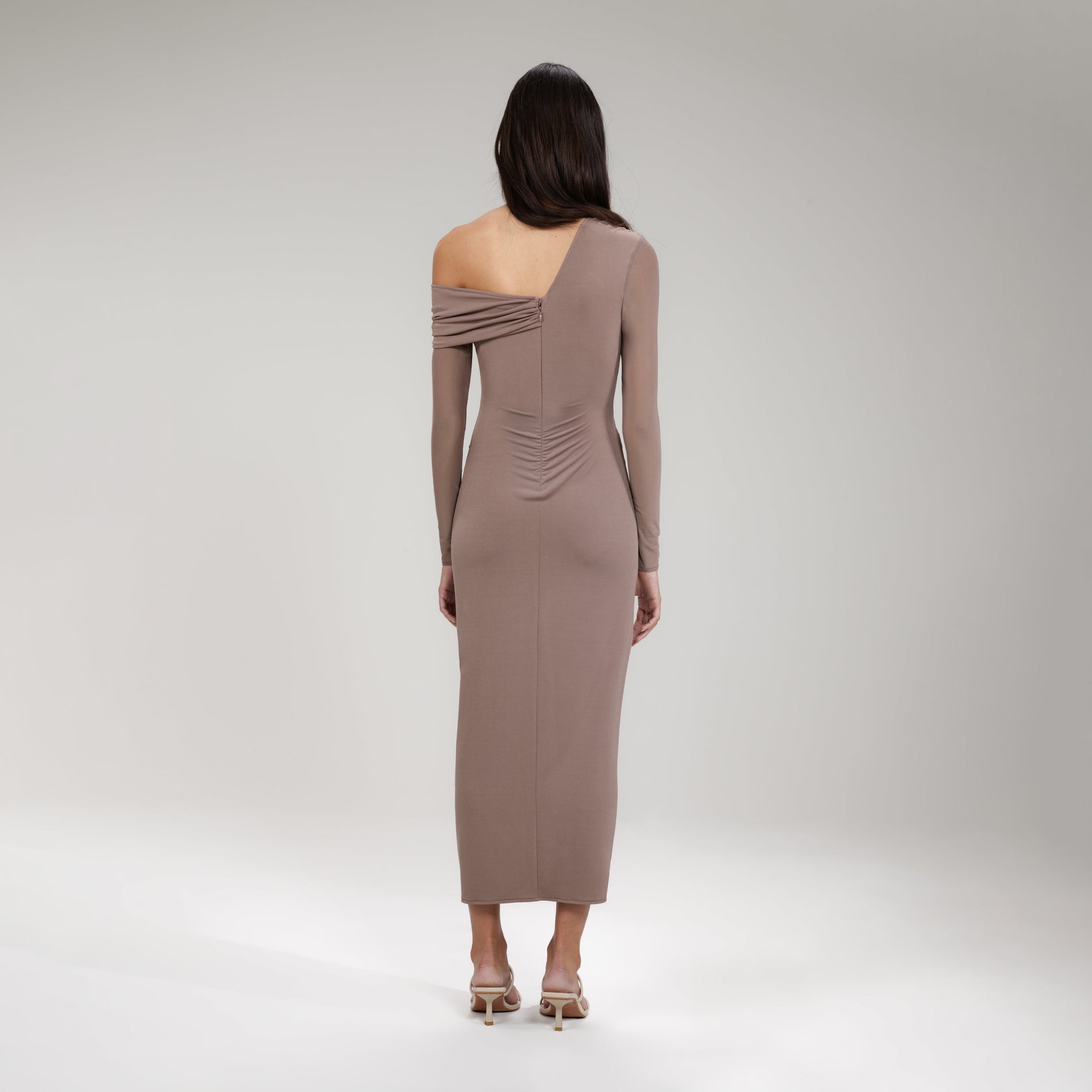 A woman wearing the Taupe Jersey One Shoulder Ruched Midi Dress