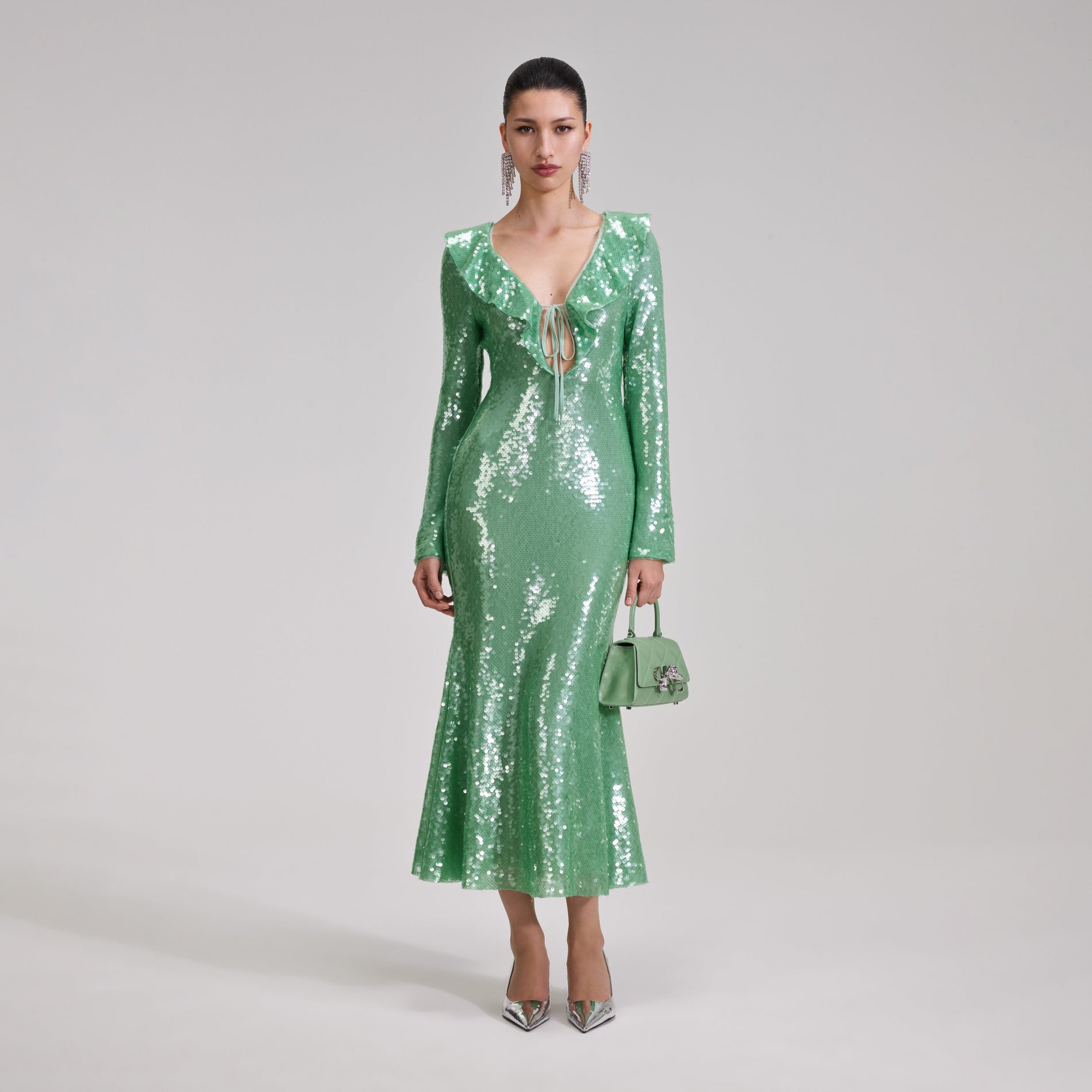 A woman wearing the Green Sequin Midi Dress