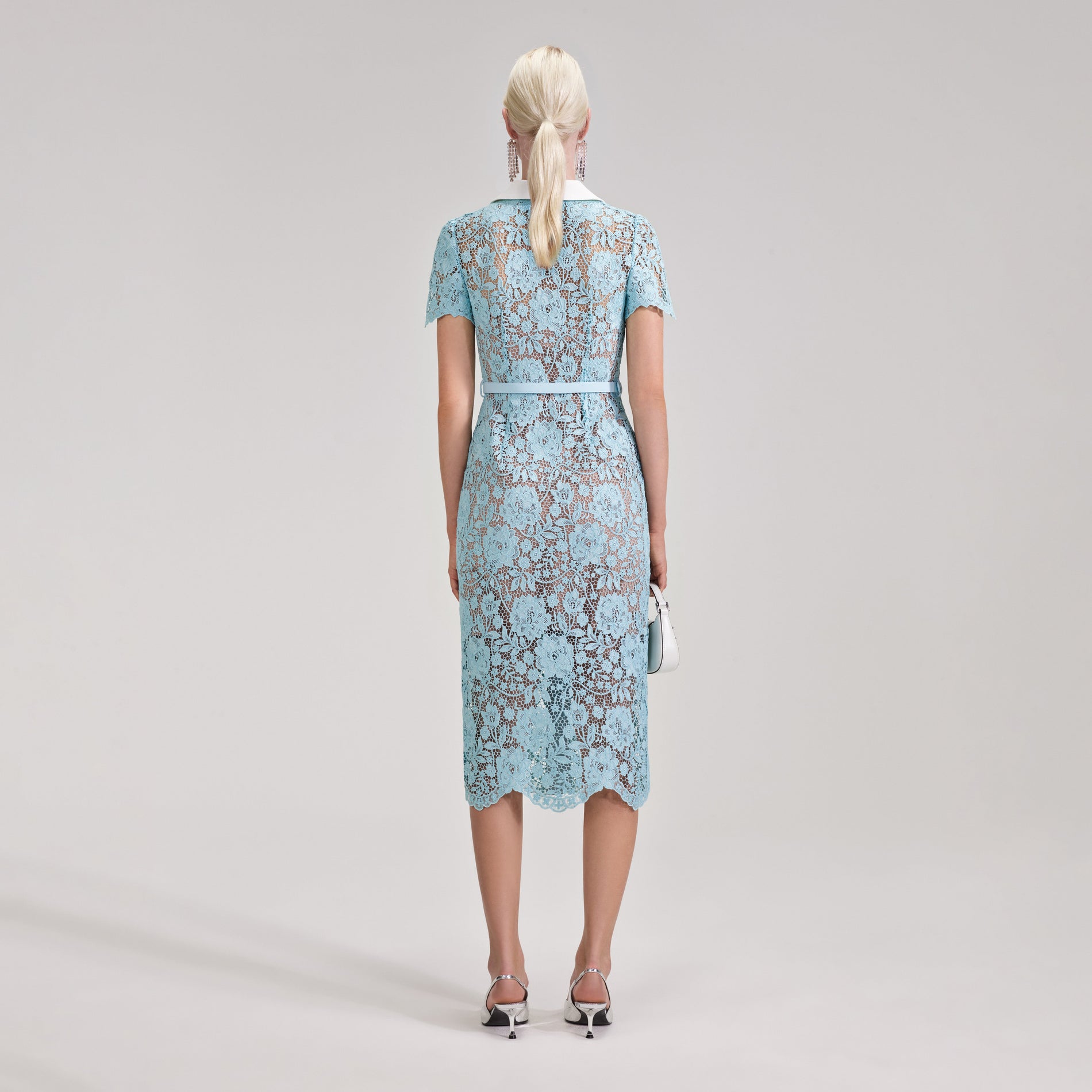 A woman wearing the Blue Cord Lace Midi Dress