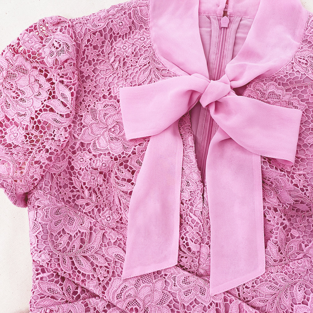 A close up of the fabric for the Pink Cord Lace Crossover Midi Dress