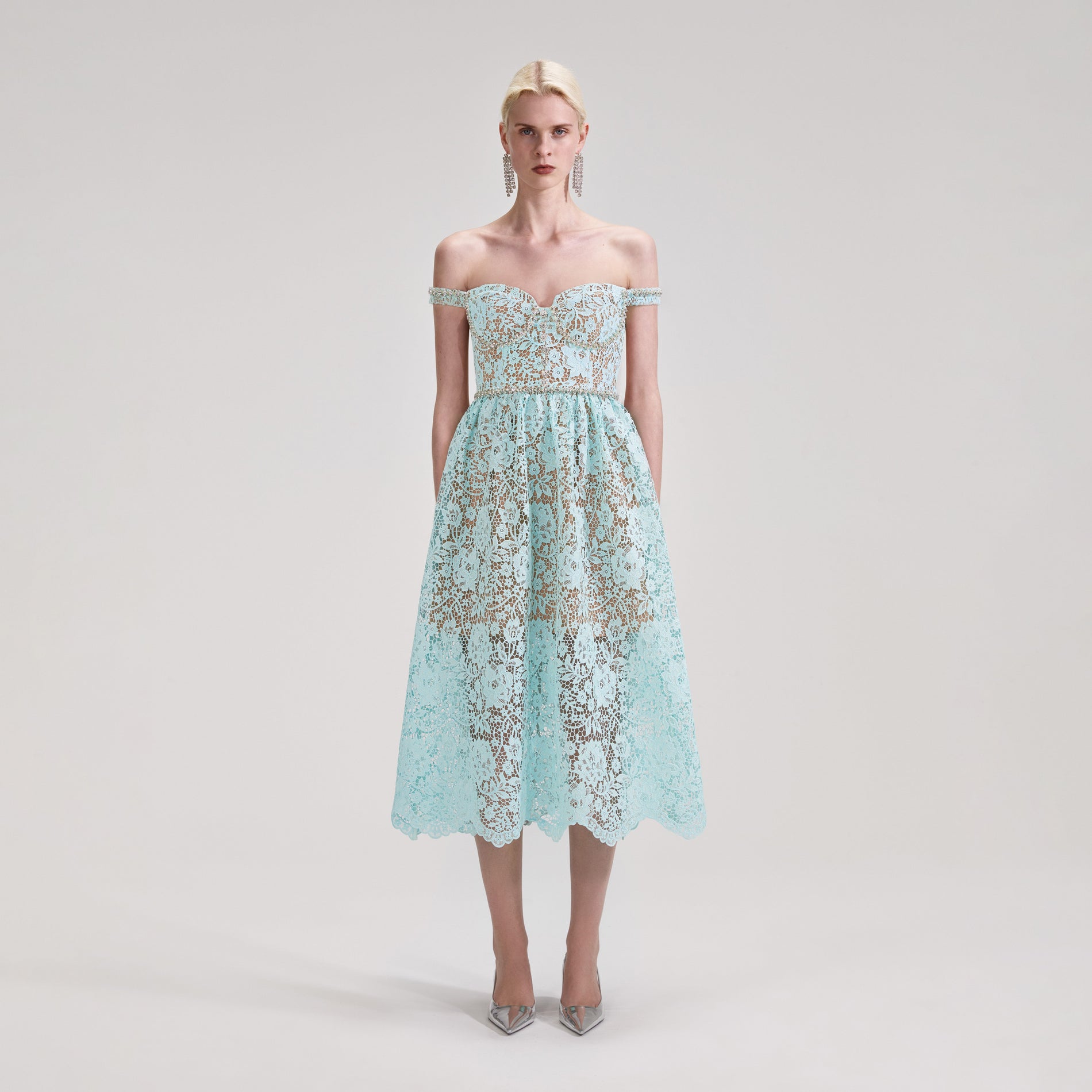 A woman wearing the Blue Cord Lace Diamante Midi Dress