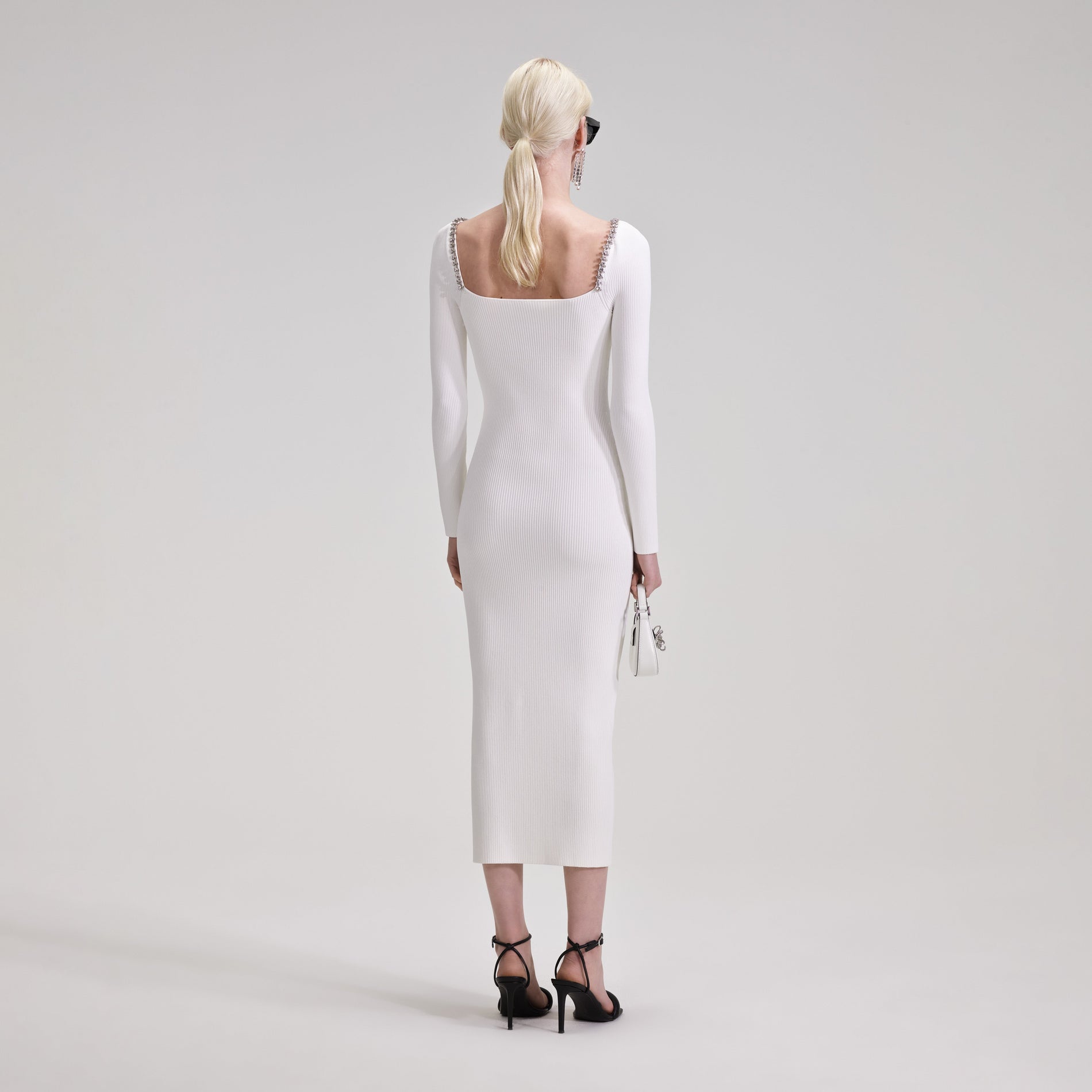 A woman wearing the White Knit Diamante Midi Dress