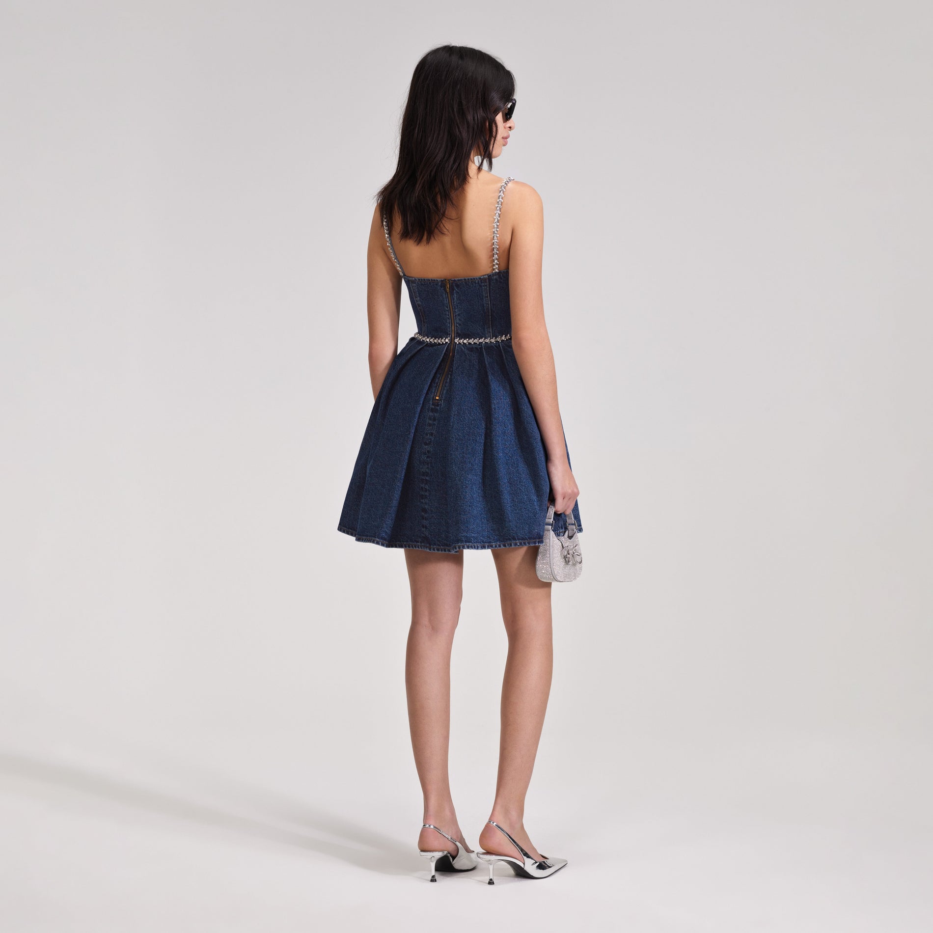 A woman wearing the Diamante Detail Denim Mini Dress