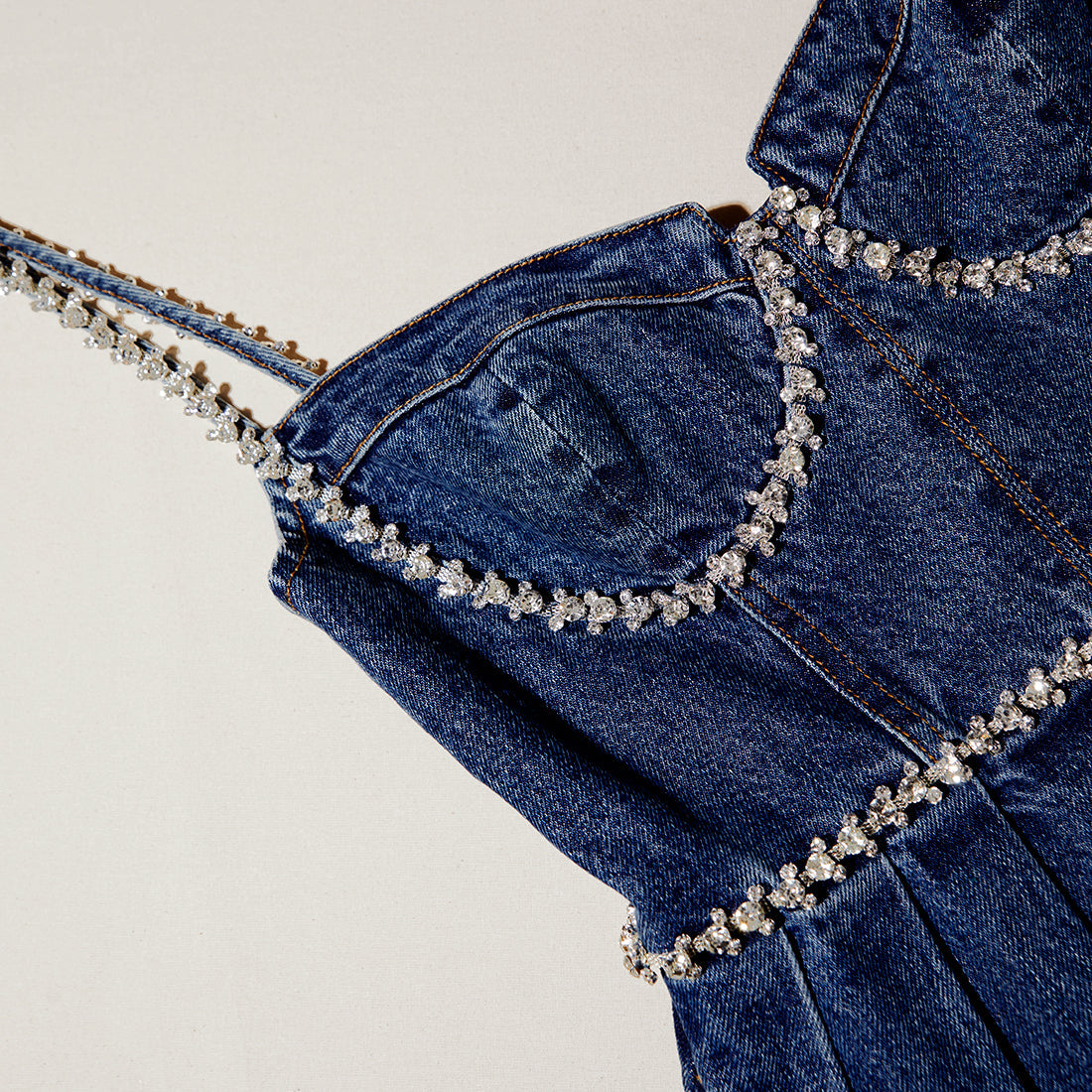 A close up of the fabric for the Diamante Detail Denim Mini Dress