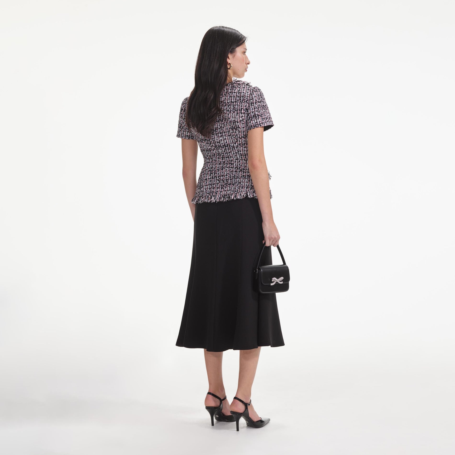 Back view of a woman wearing the Black Boucle Fringed Midi Dress