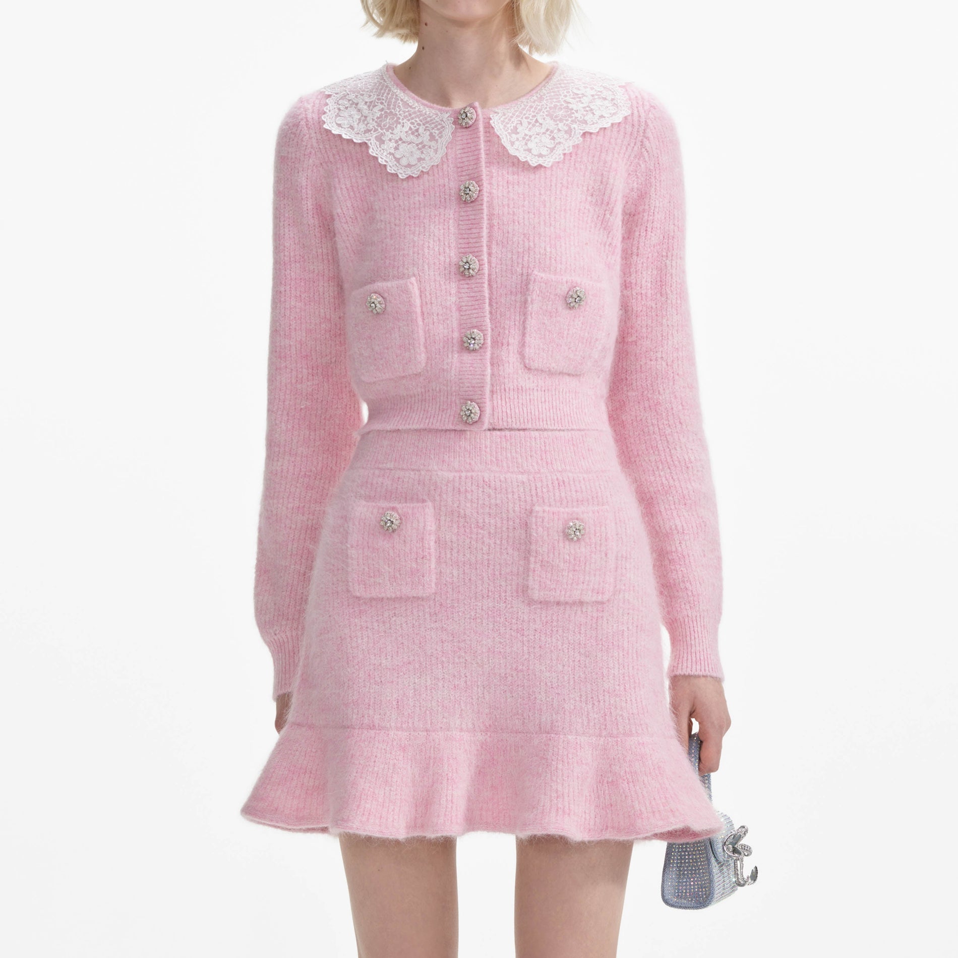 A close up of a woman wearing the Pink Fluffy Rib Knit Mini Skirt