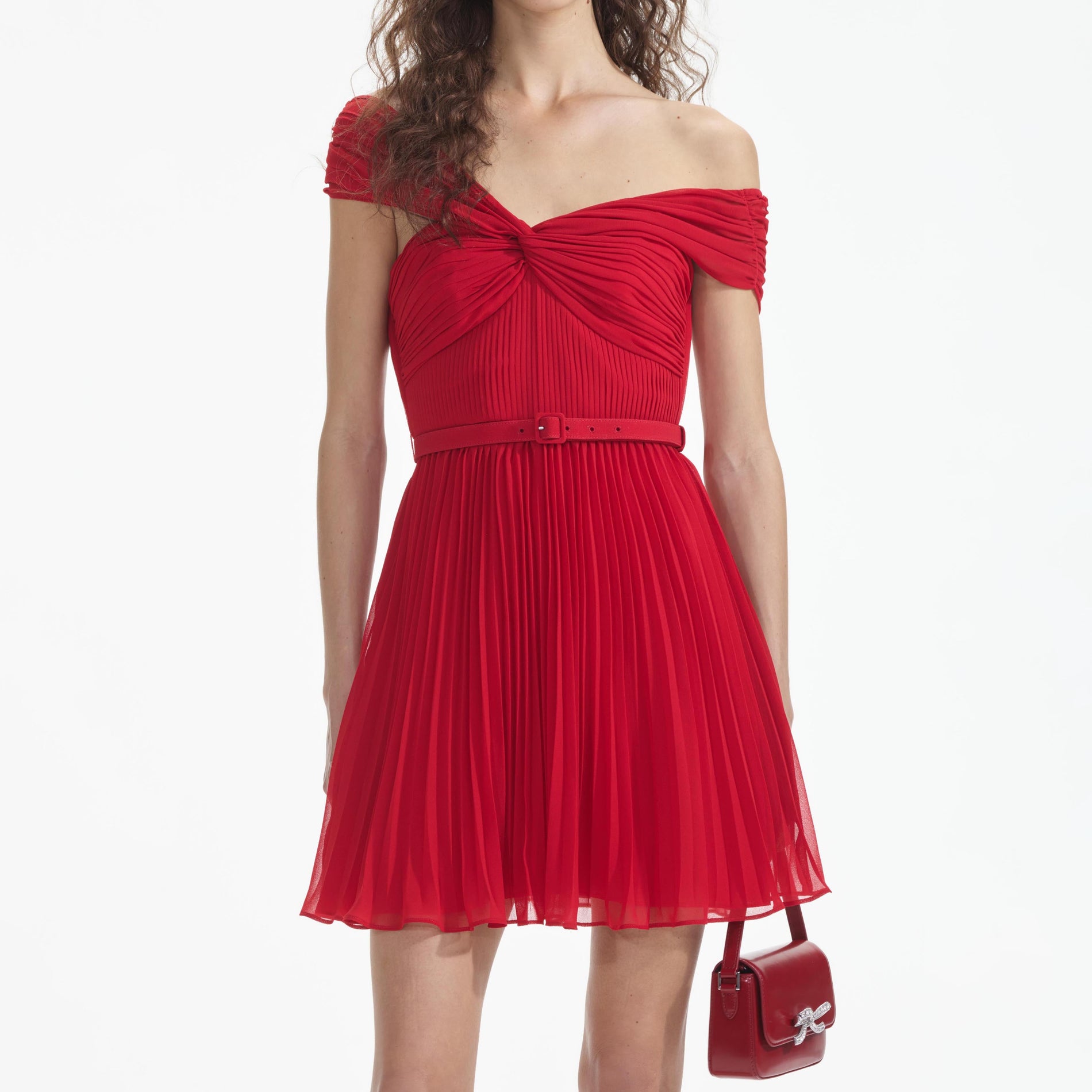 A close up of a woman wearing the Red Off Shoulder Chiffon Mini Dress