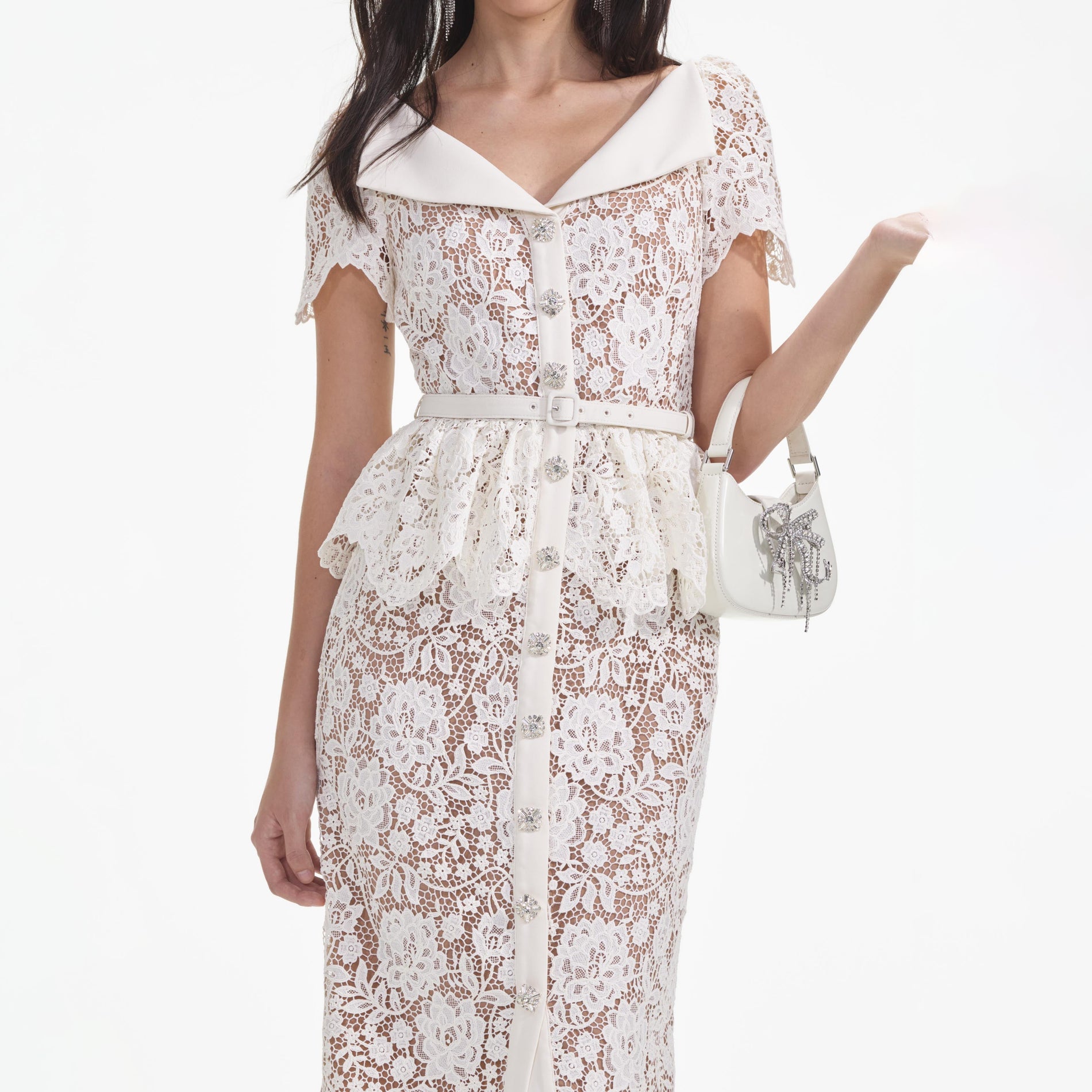 A close up of a woman wearing the Cream Lace Peplum Midi Dress