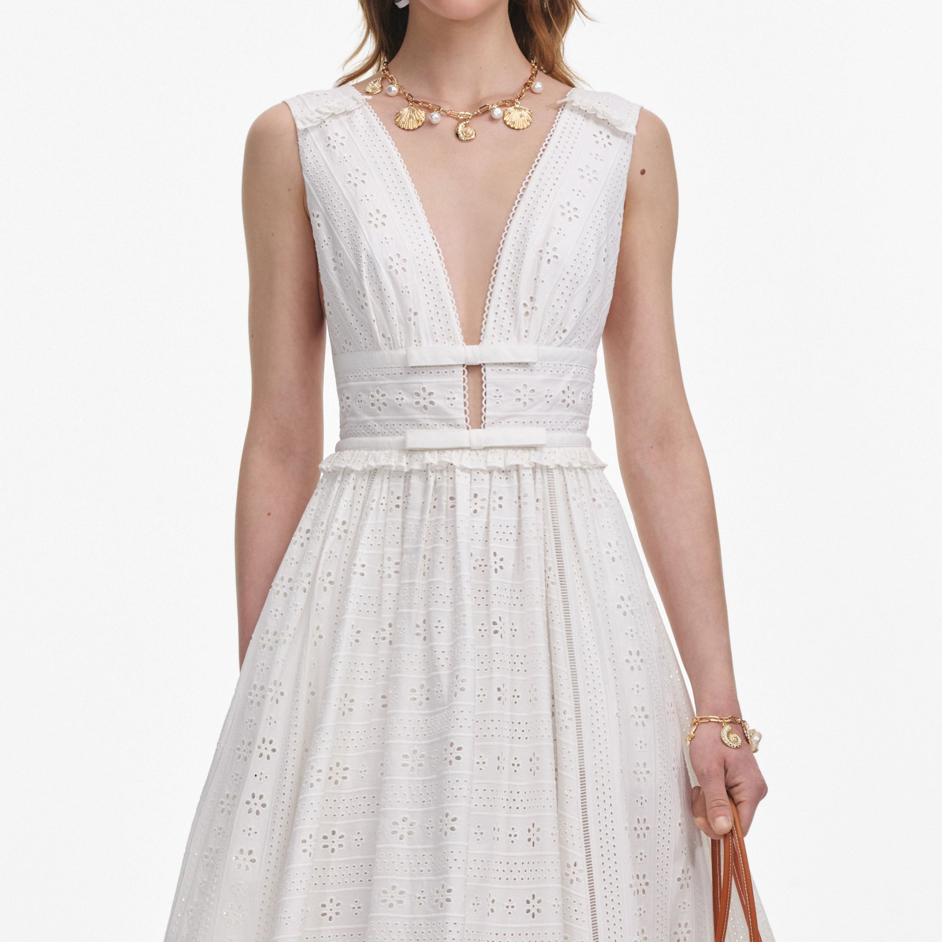 A close up of a woman wearing the White Cotton Broderie Midi Dress