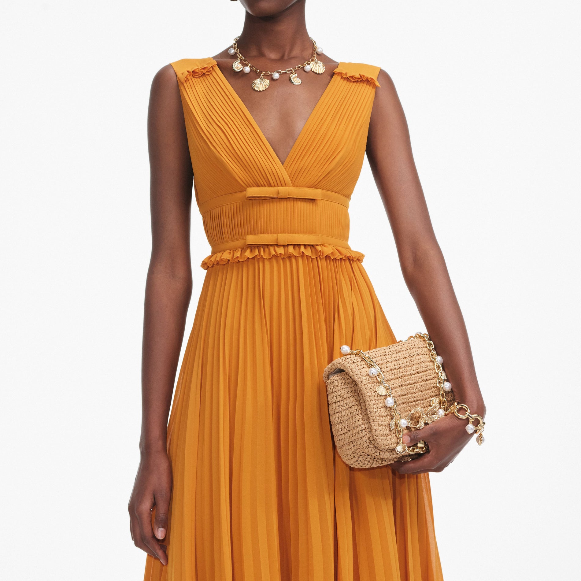 A close up of a woman wearing the Burnt Orange Chiffon Midi Dress