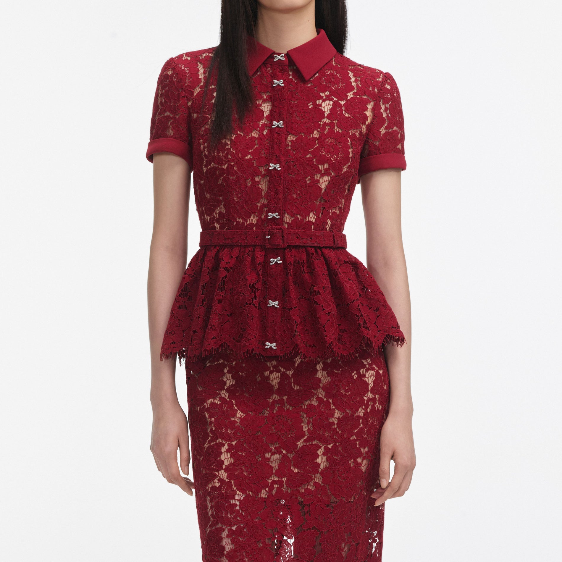 A close up of a woman wearing the Burgundy Lace Peplum Midi Dress