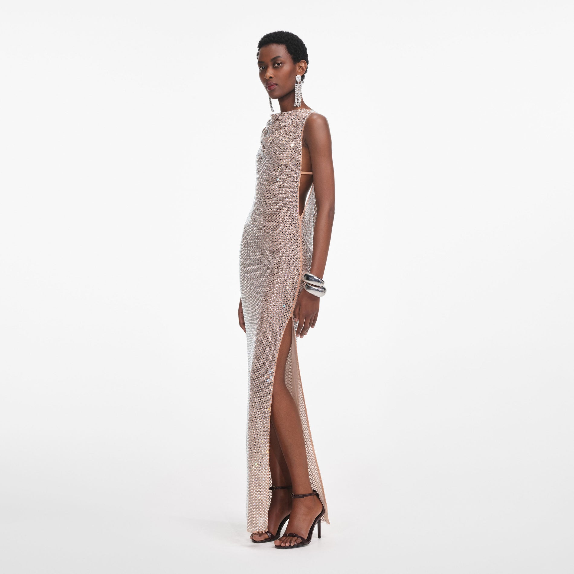 Side view of a woman wearing the Silver Rhinestone Drape Maxi Dress