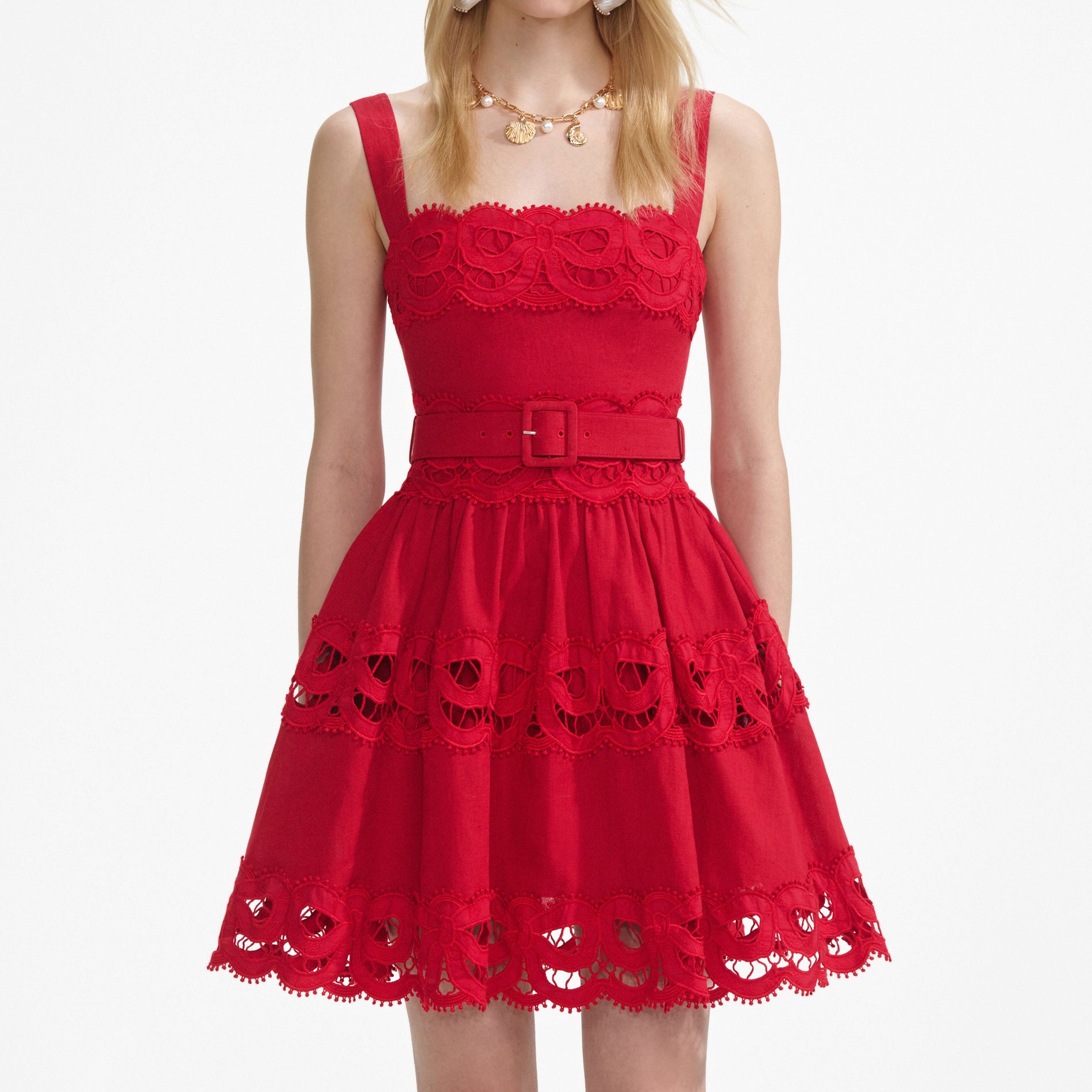 A close up of a woman wearing the Red Linen Lace Insert Mini Dress