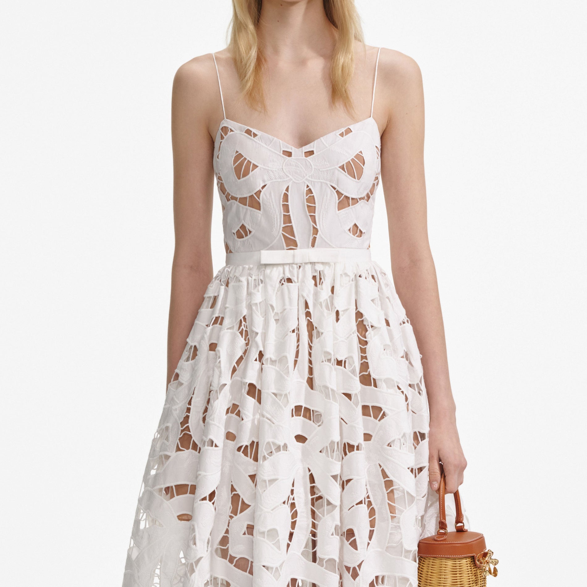 A close up of a woman wearing the White Bow Embroidered Midi Dress
