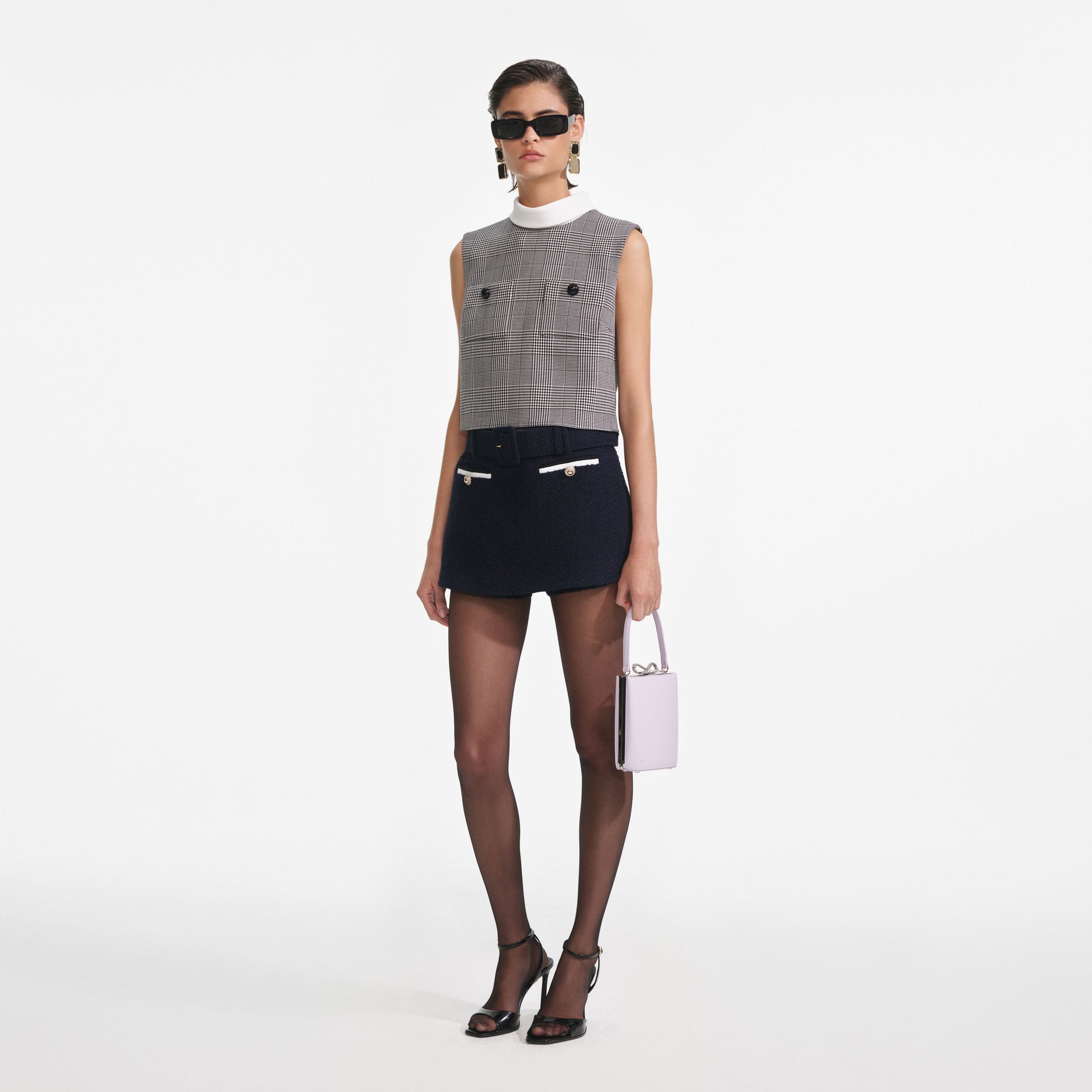 Side view of a woman wearing the Navy Boucle Skort