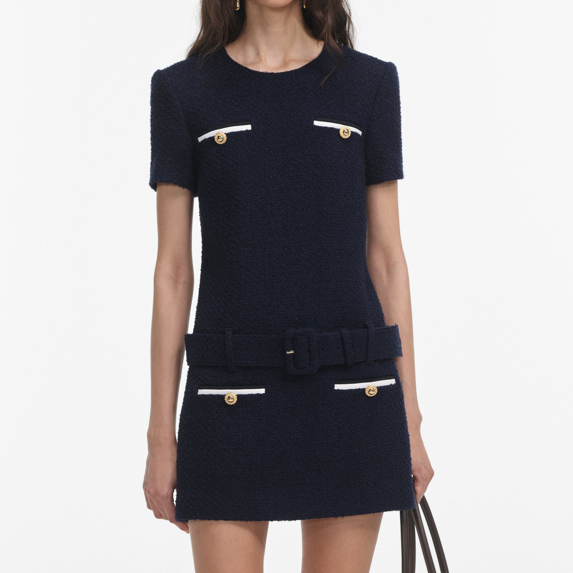 A close up of a woman wearing the Navy Boucle Mini Dress