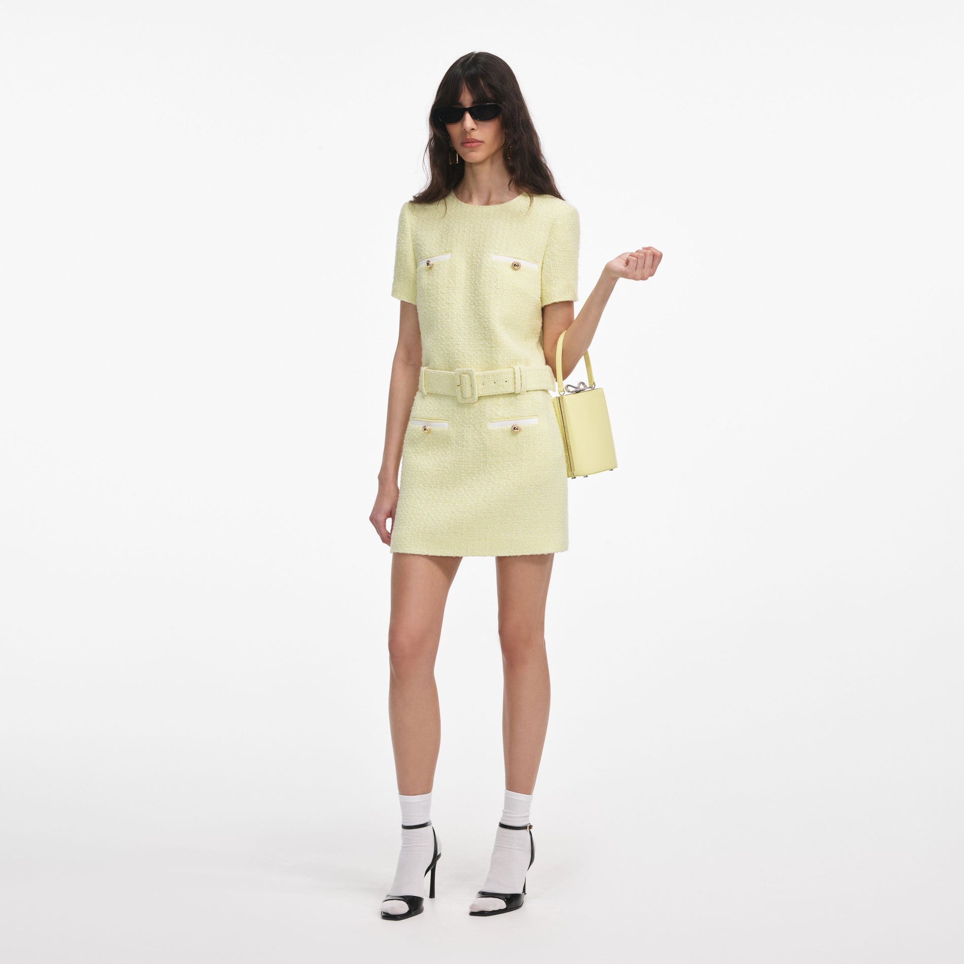 Side view of a woman wearing the Yellow Boucle Mini Dress