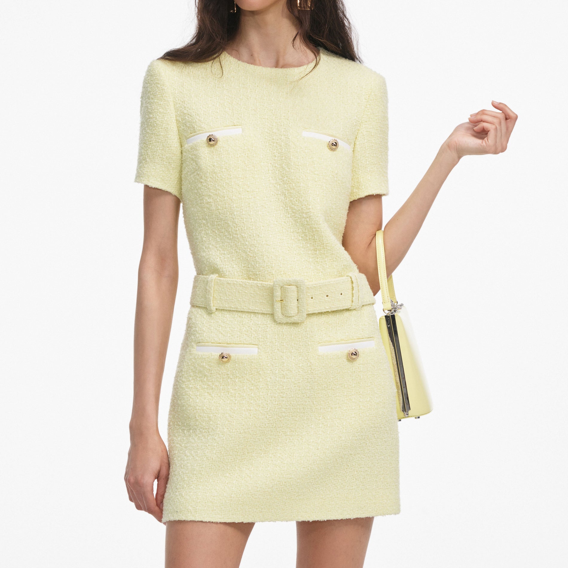 A close up of a woman wearing the Yellow Boucle Mini Dress