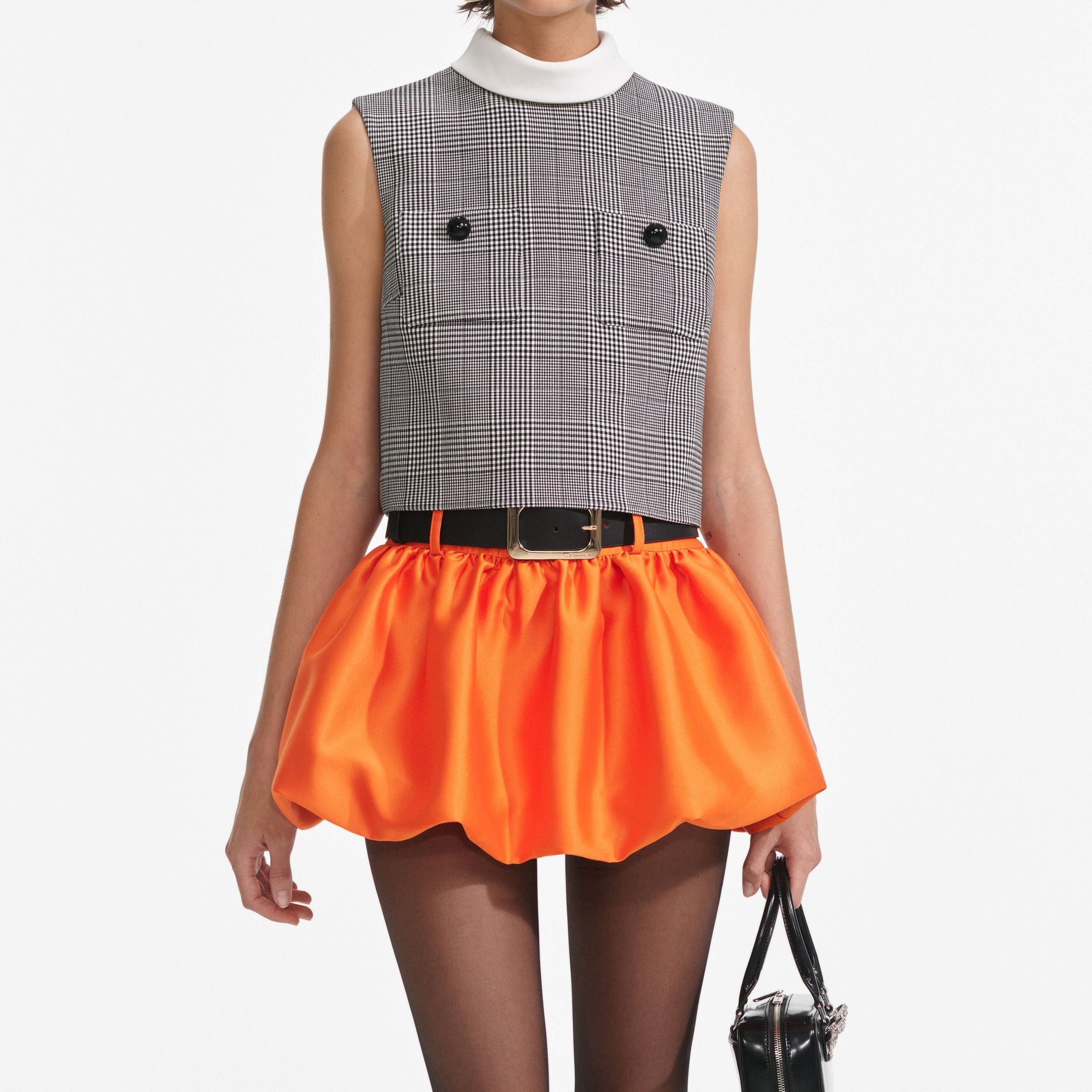 A close up of a woman wearing the Prince Of Wales Check Top