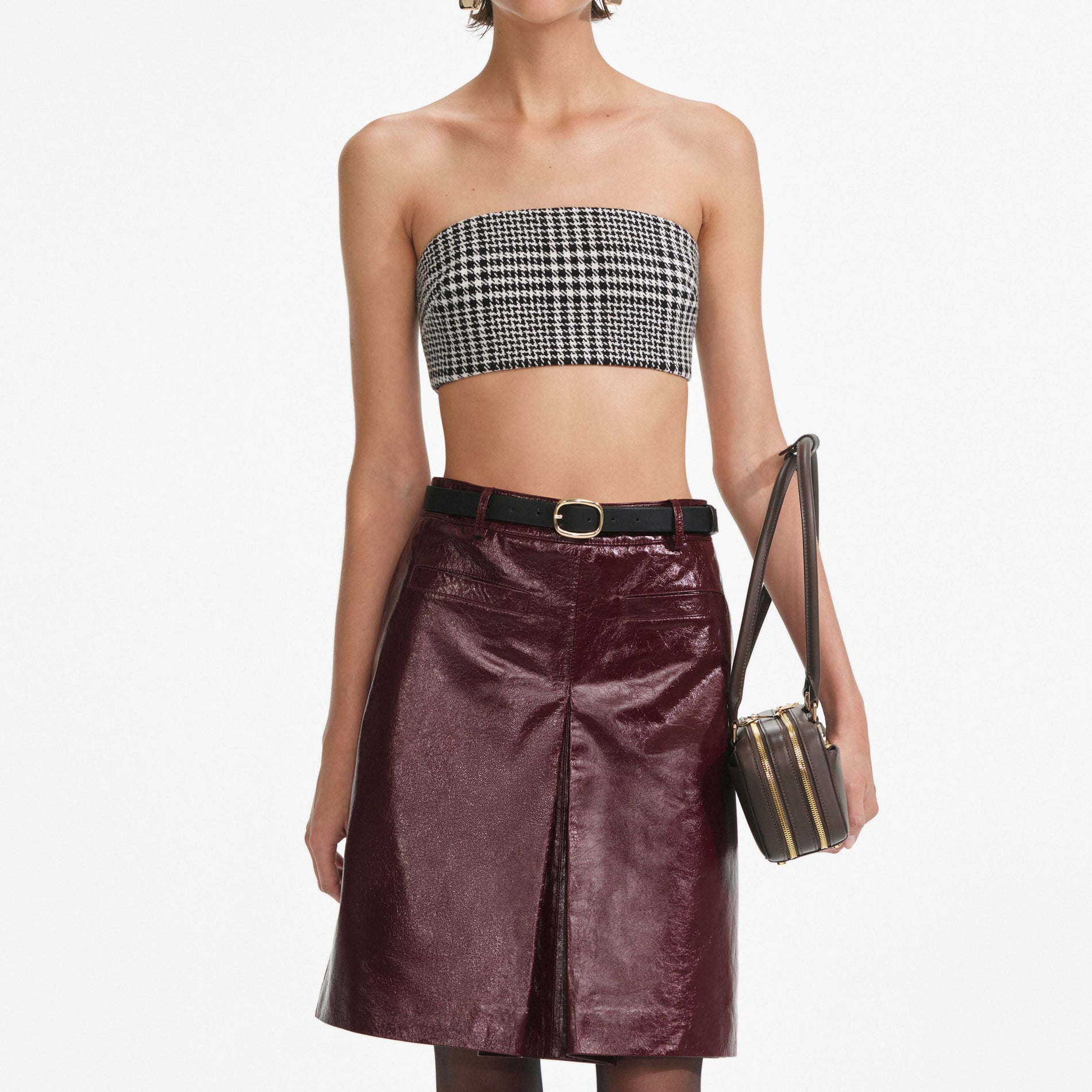 A close up of a woman wearing the Burgundy Leather  Mini Skirt