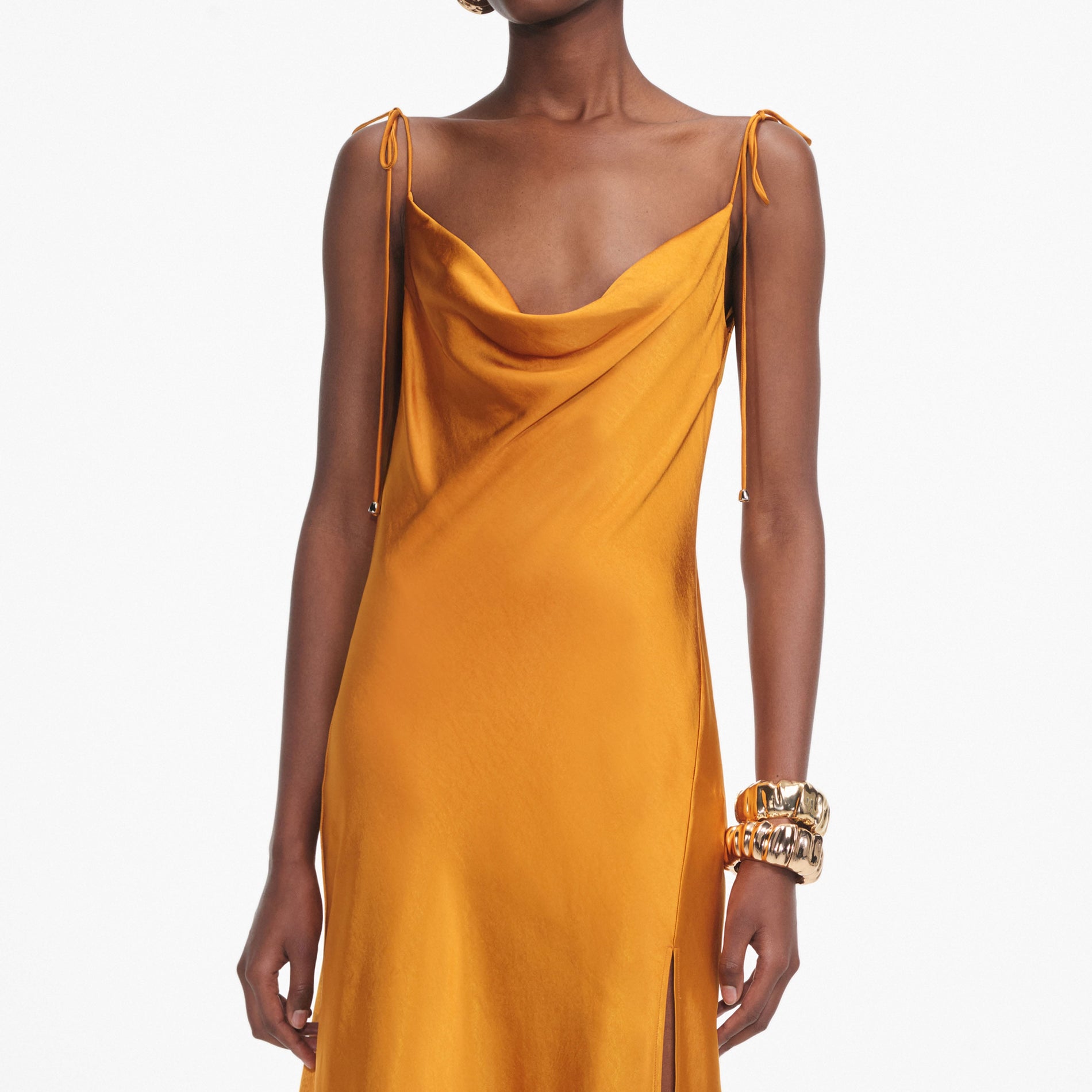A close up of a woman wearing the Burnt Orange Satin Midi Dress