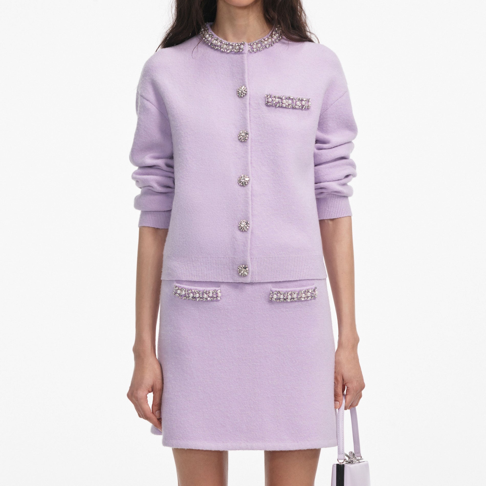 A close up of a woman wearing the Lilac Crystal Trim Knit Skirt