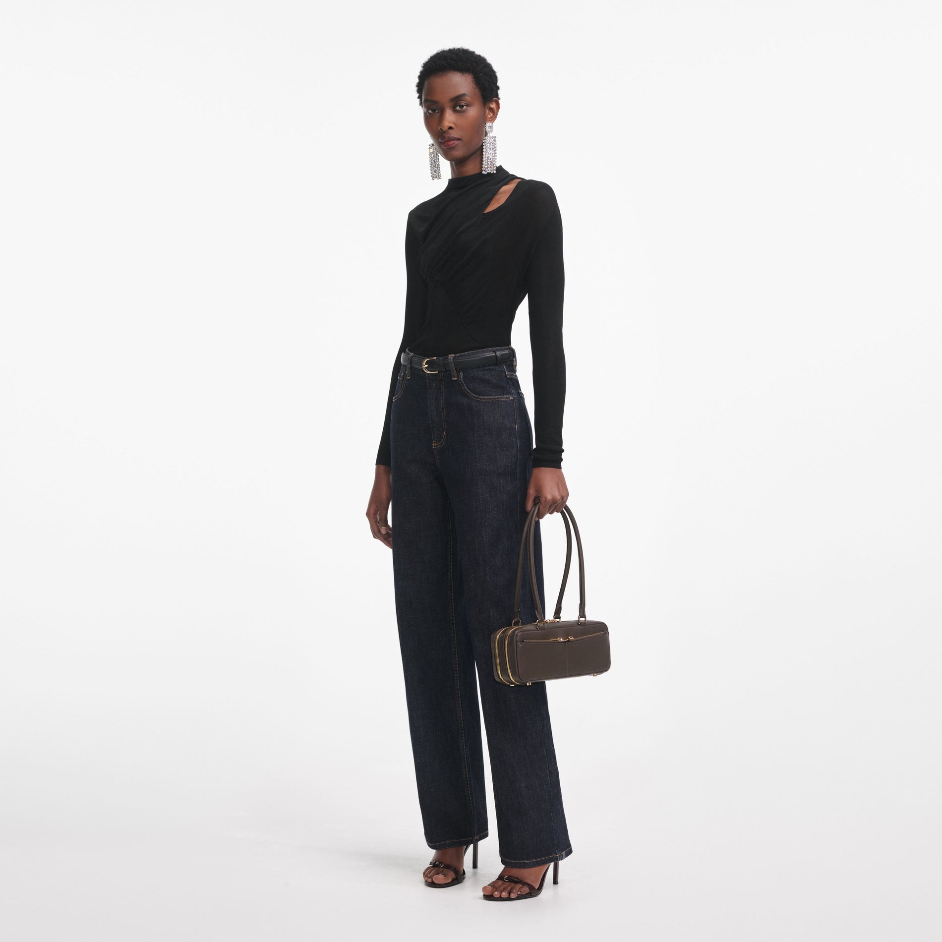 Side view of a woman wearing the Black Cut Out Viscose Knit Top