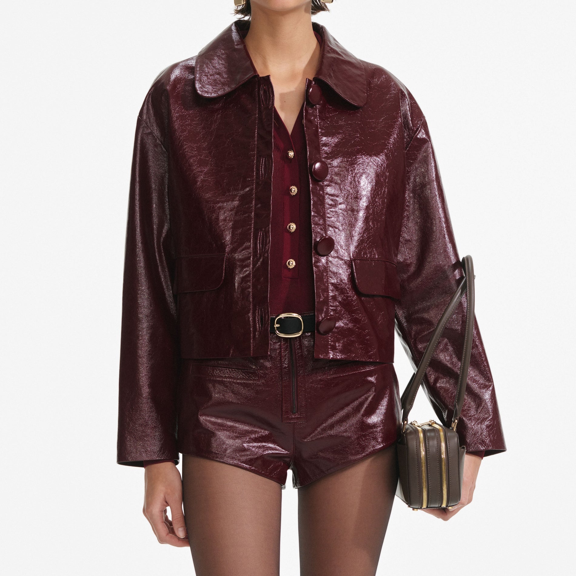 A close up of a woman wearing the Burgundy Leather  Jacket