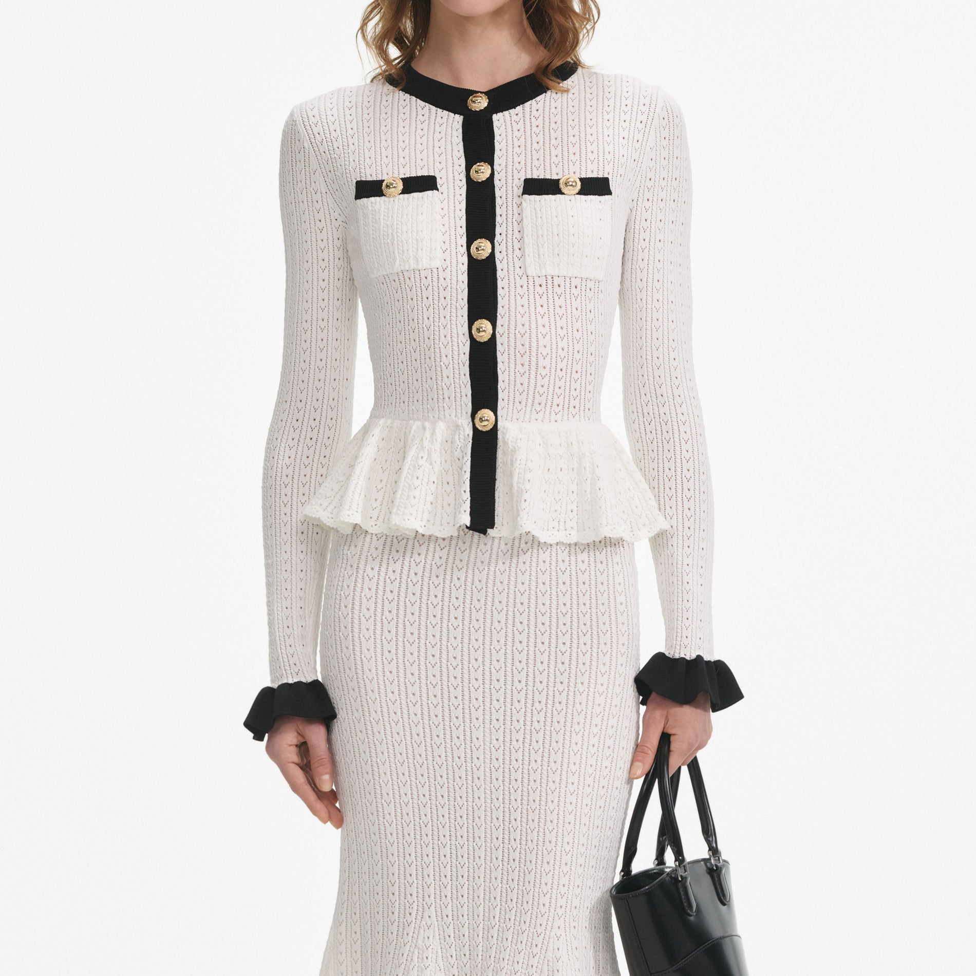A close up of a woman wearing the White Pointelle Knit Contrast Midi Dress