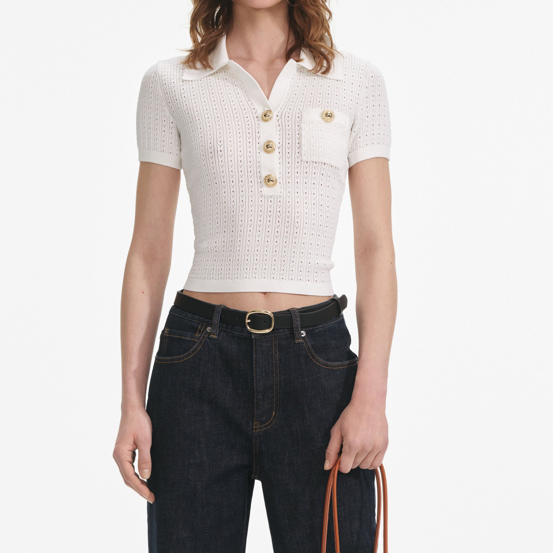 A close up of a woman wearing the White Pointelle Knit Top