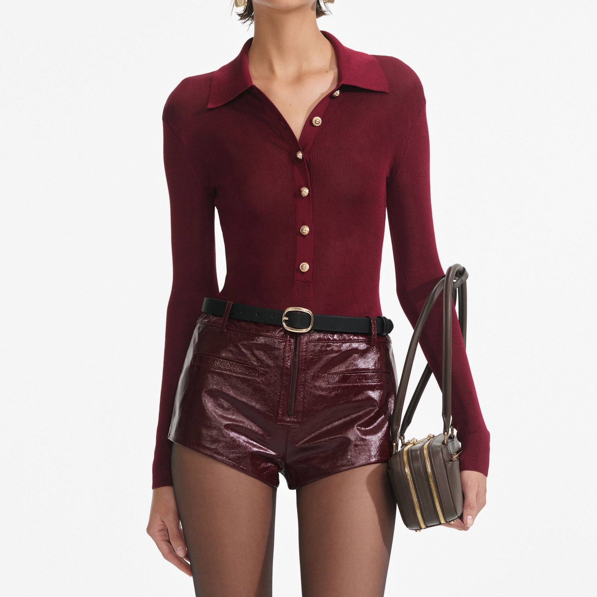 A close up of a woman wearing the Burgundy Viscose Knit Bodysuit