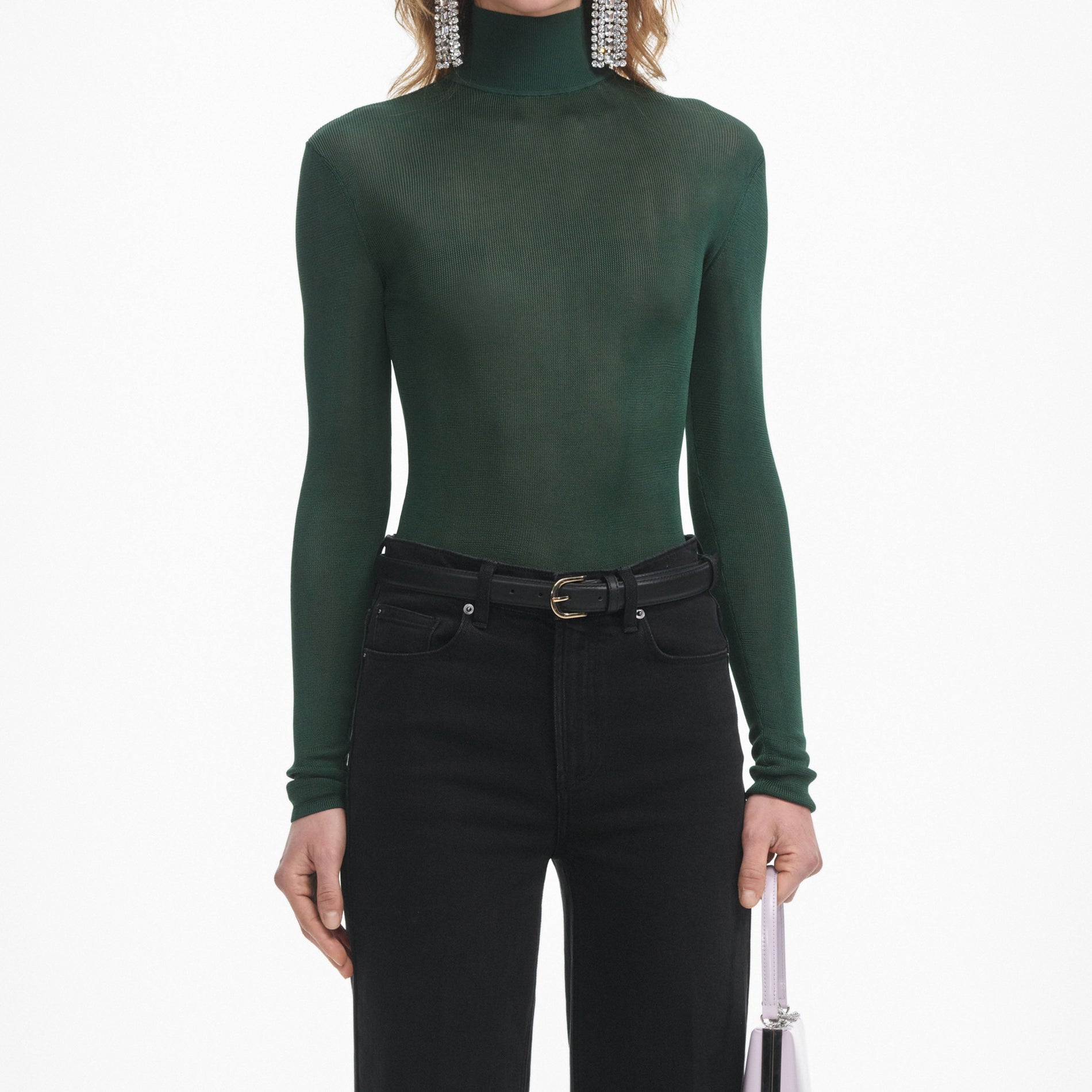 A close up of a woman wearing the Black Flared Jeans