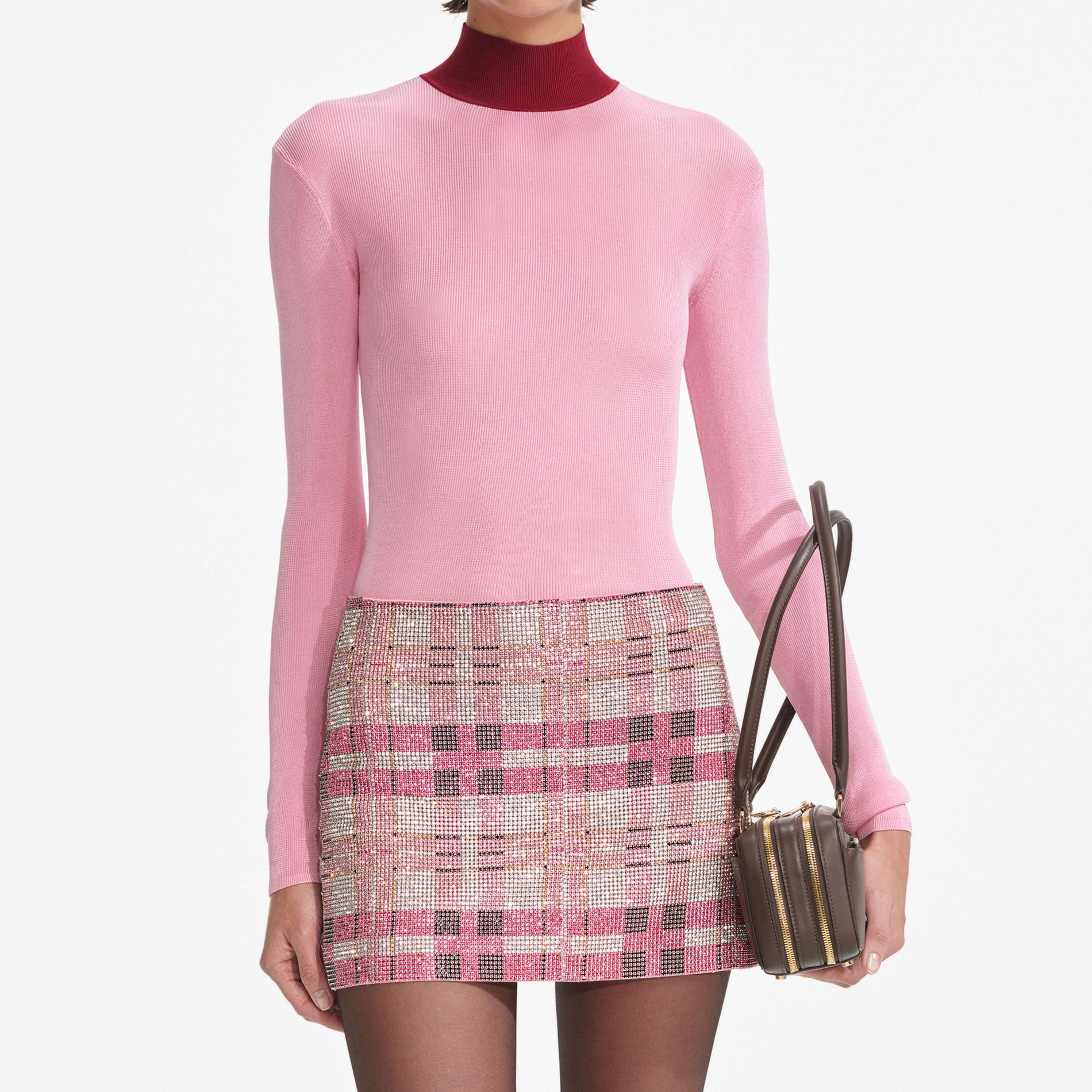 A close up of a woman wearing the Pink Viscose Knit Top