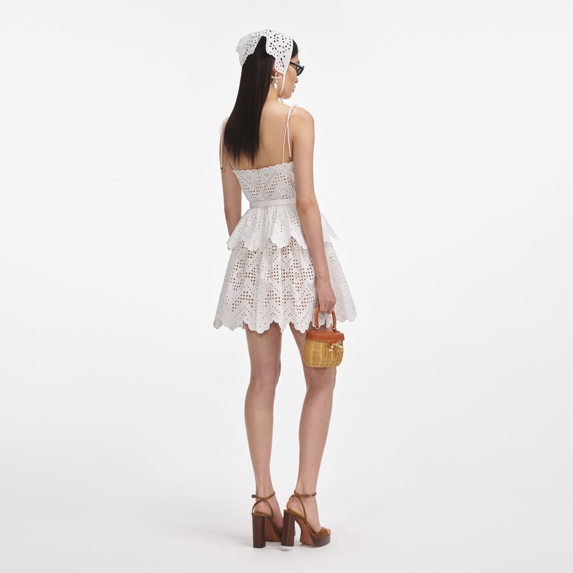 Back view of a woman wearing the White Cotton Broderie Mini Dress