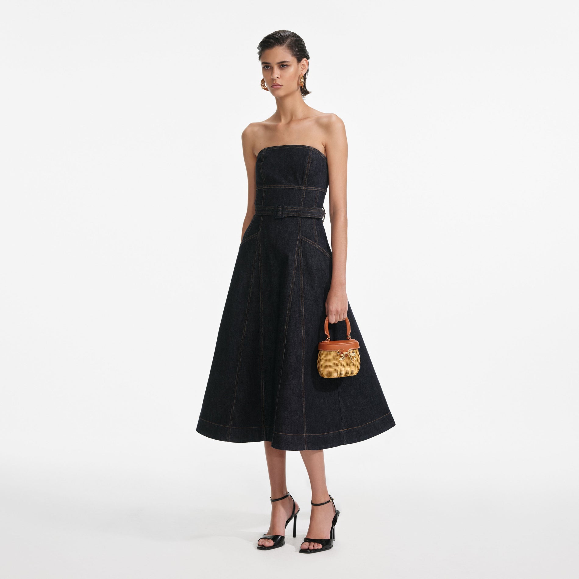 Side view of a woman wearing the Indigo Denim Bandeau Midi Dress