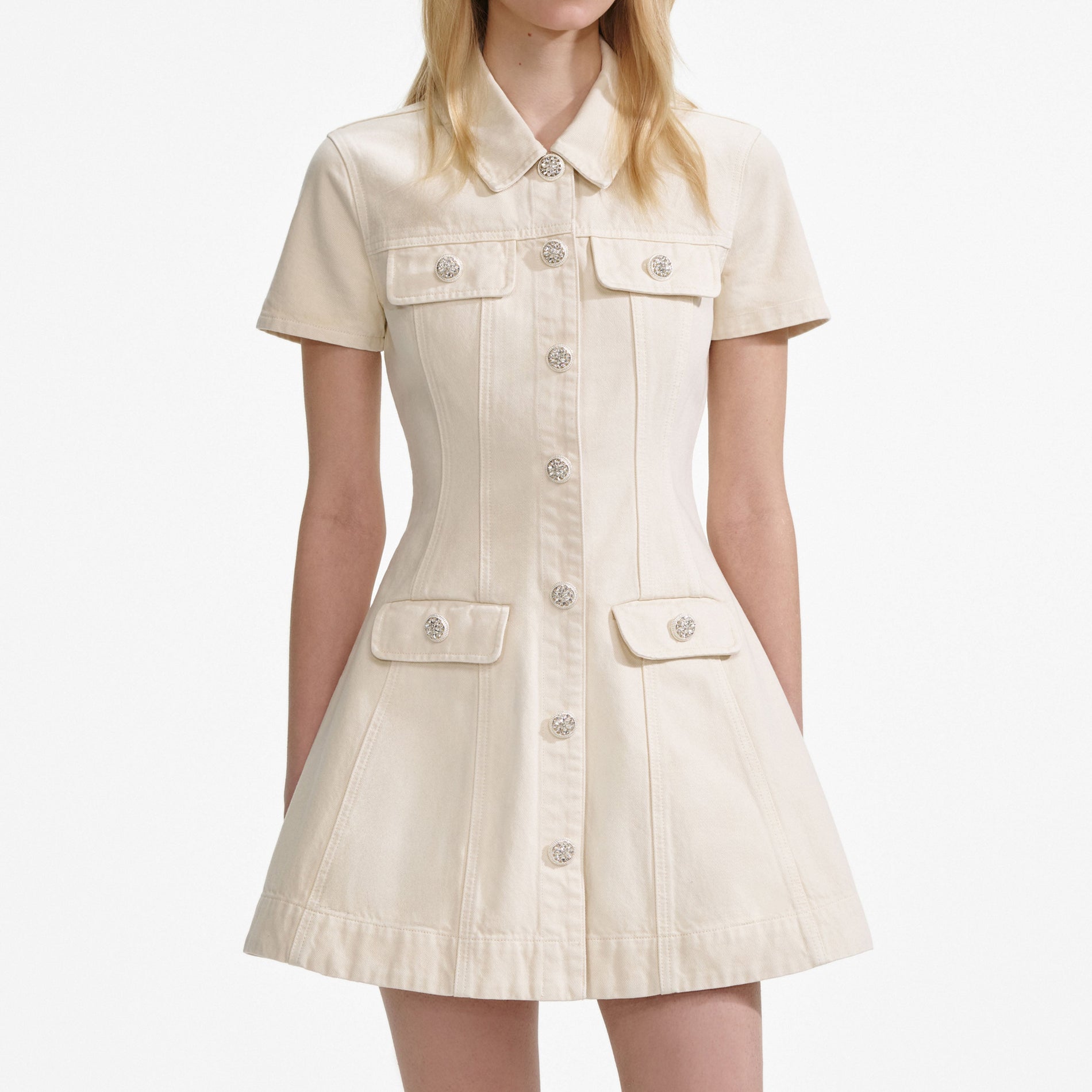 A close up of a woman wearing the Cream Collared Denim Mini Dress