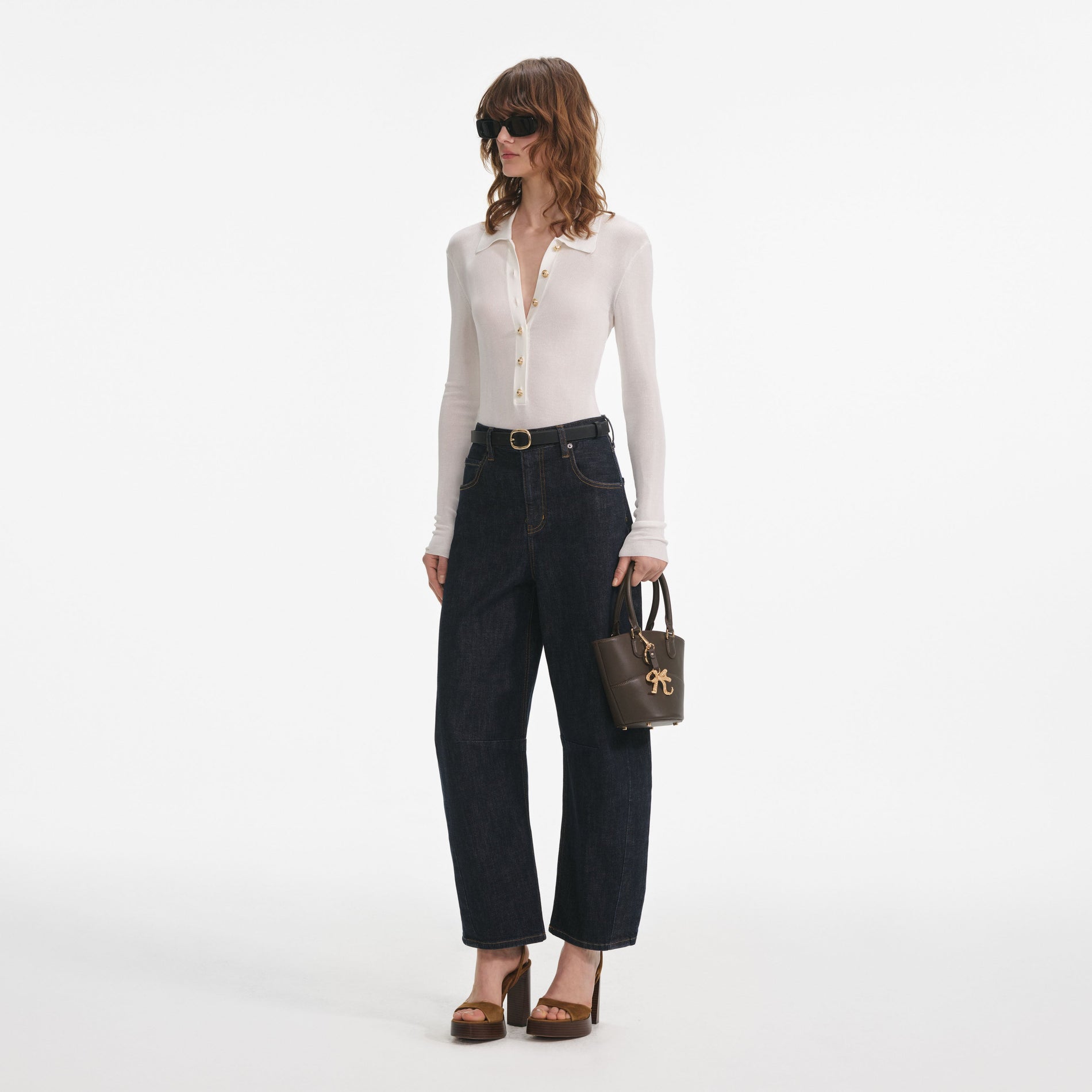 Side view of a woman wearing the Indigo Barrel Leg Jeans