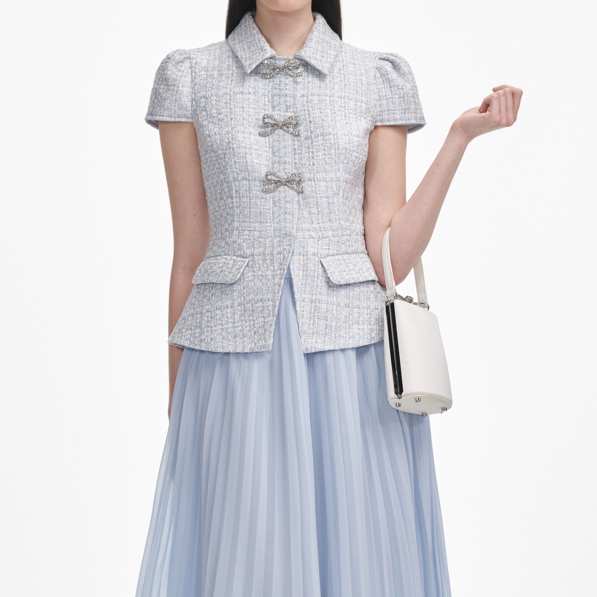 A close up of a woman wearing the Blue Boucle Bow Midi Dress