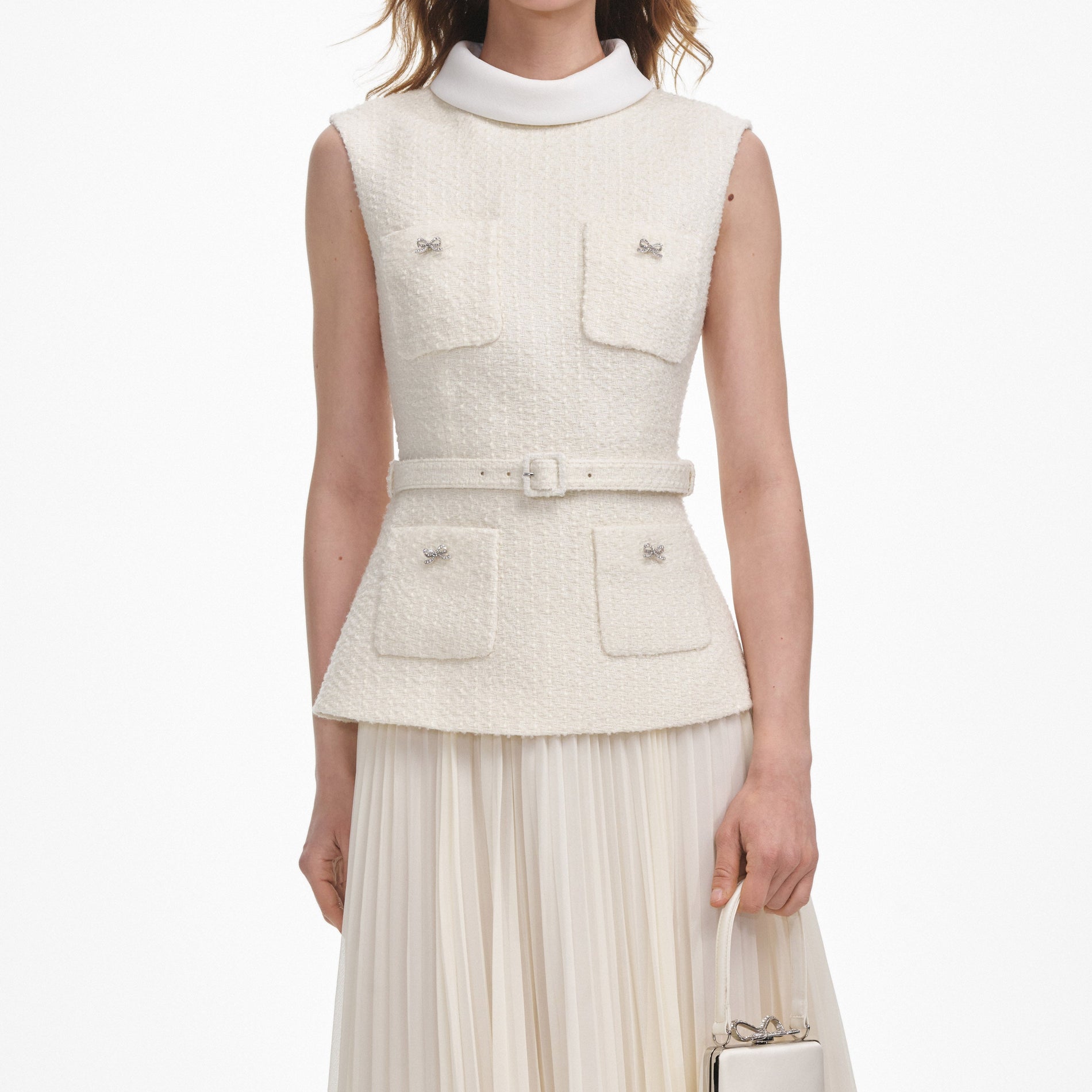 A close up of a woman wearing the Cream Boucle Sleeveless Midi Dress