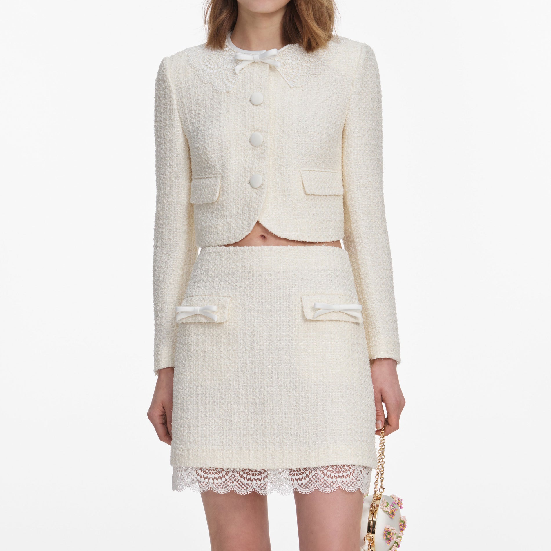 A close up of a woman wearing the Cream Boucle Lace Mini Skirt